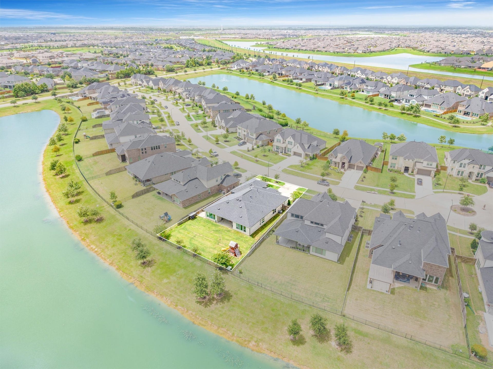 This aerial perspective highlights the community layout, showcasing its streets, homes, and shared amenities for a comprehensive view of the neighborhood.