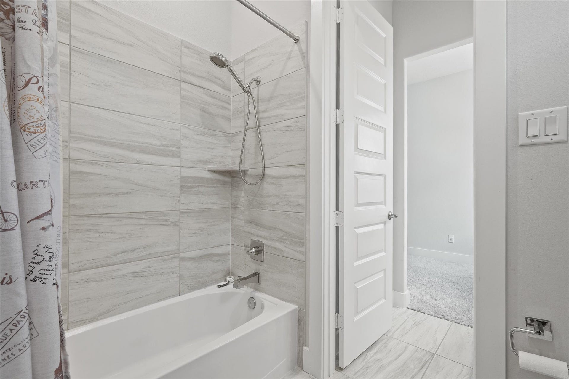 Designed with both comfort and convenience in mind, this Jack-and-Jill bathroom features a shared shower/tub combo and a private toilet area, making it perfect for everyday living.
