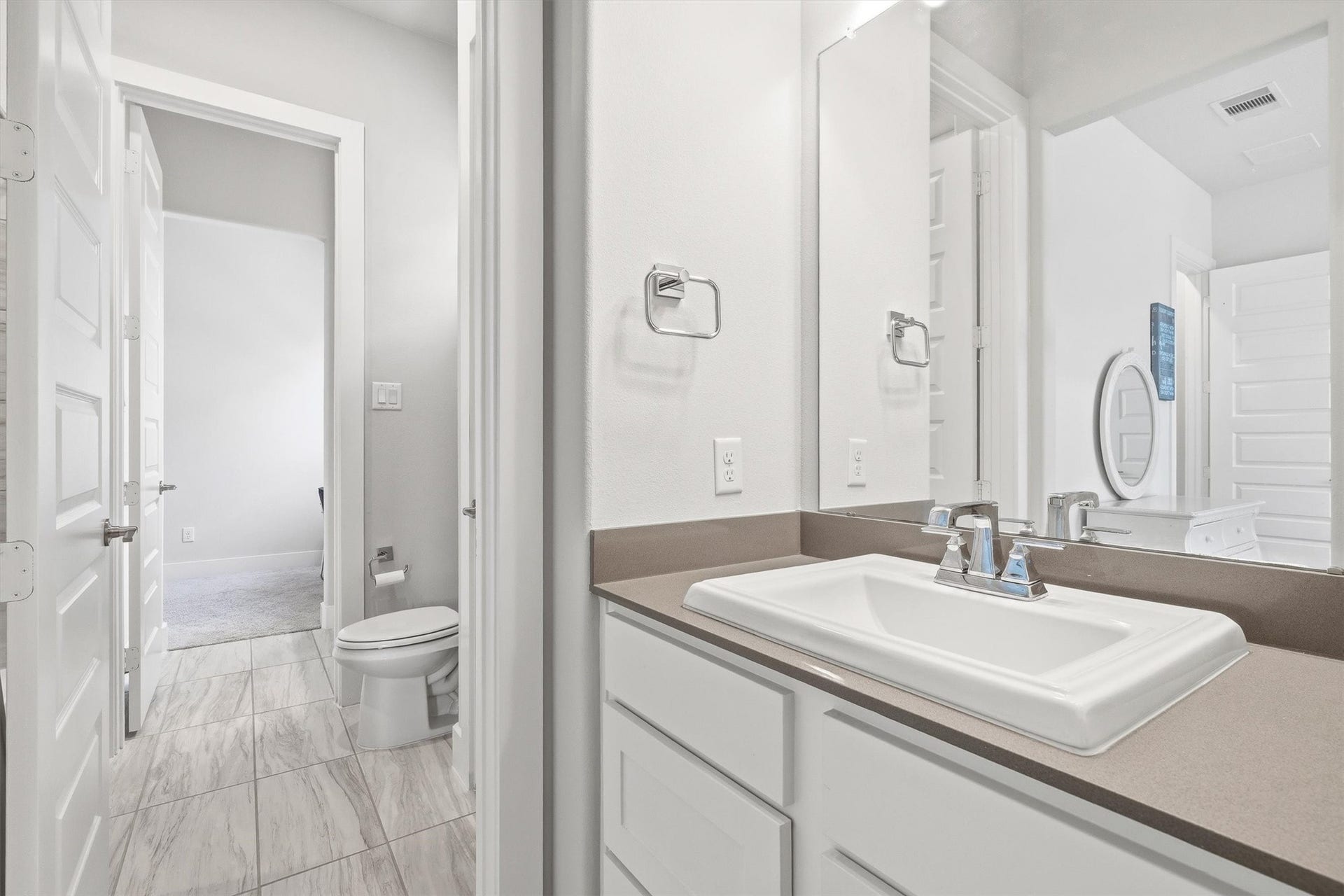Another view highlights the private sink vanity, offering a personal grooming space with direct access to the Jack-and-Jill bathroom for added comfort and convenience.