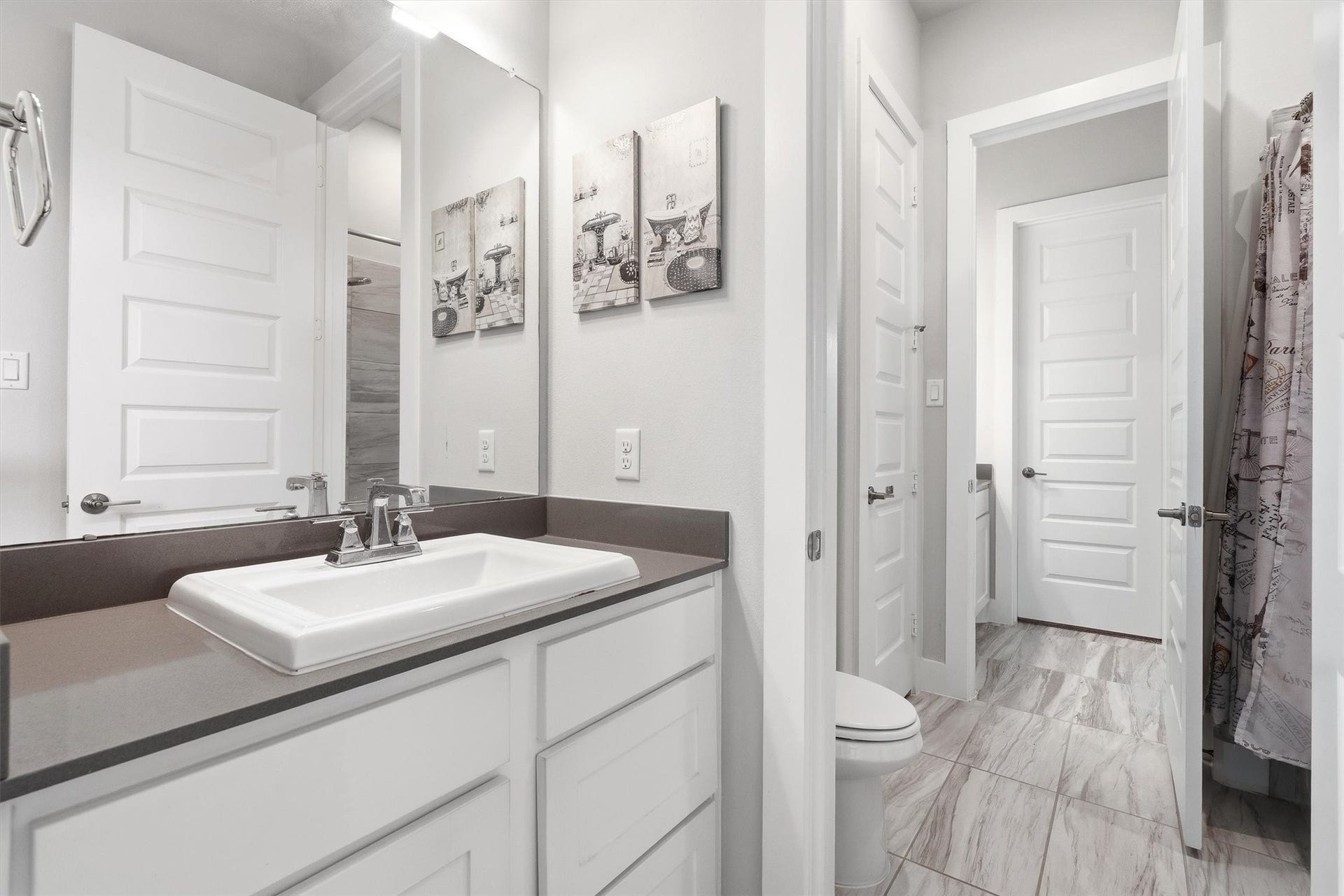 This view showcases the private sink vanity that provides direct access to the Jack-and-Jill bathroom, offering added convenience and privacy.