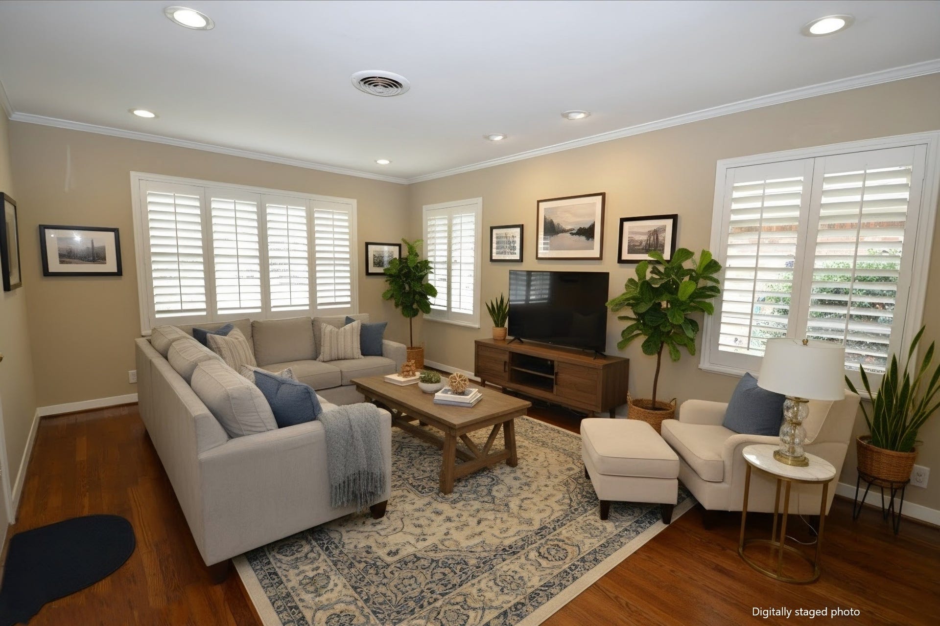 Living room features hardwood floors, newer windows with plantation shutters and dimmable recessed LED lights.