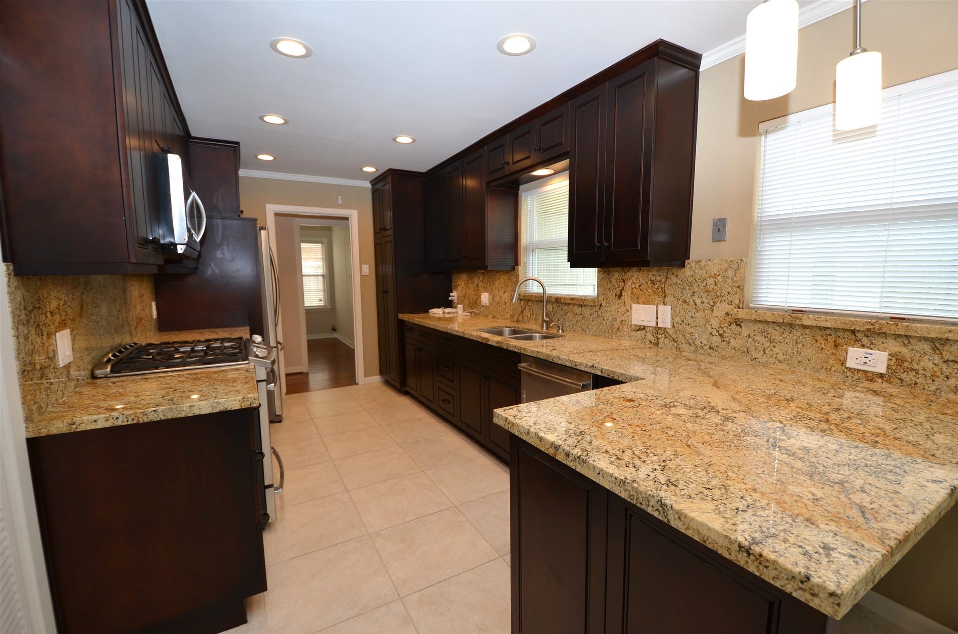 Breakfast bar area with dimmable recessed and stylish pendant lights.