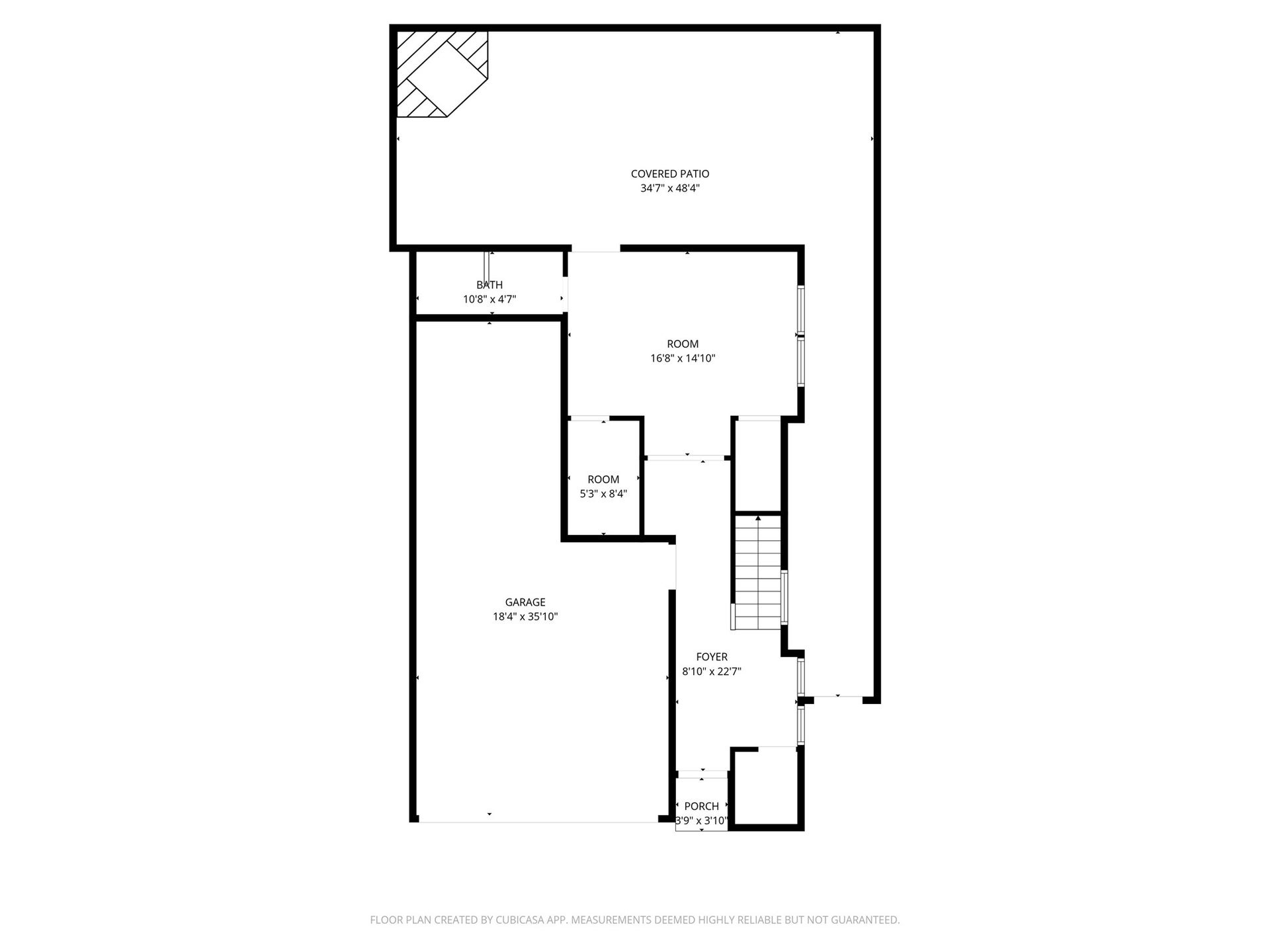 First-floor plan highlighting the private guest suite, entry, garage, and outdoor entertaining access.