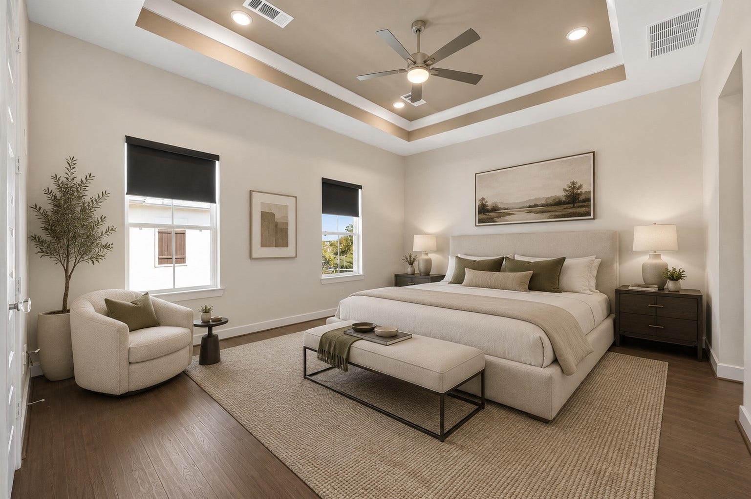 Spacious primary suite featuring tray ceilings, abundant natural light, and generous proportions designed for comfort. Furniture shown has been virtually staged for illustrative purposes.