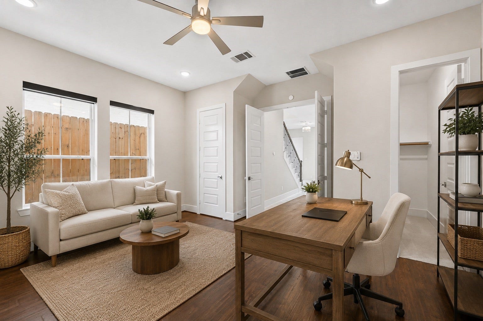 Alternate view of the first-floor guest suite demonstrating flexibility for guests, home office, or multigenerational living. Furniture shown has been virtually staged for illustrative purposes.