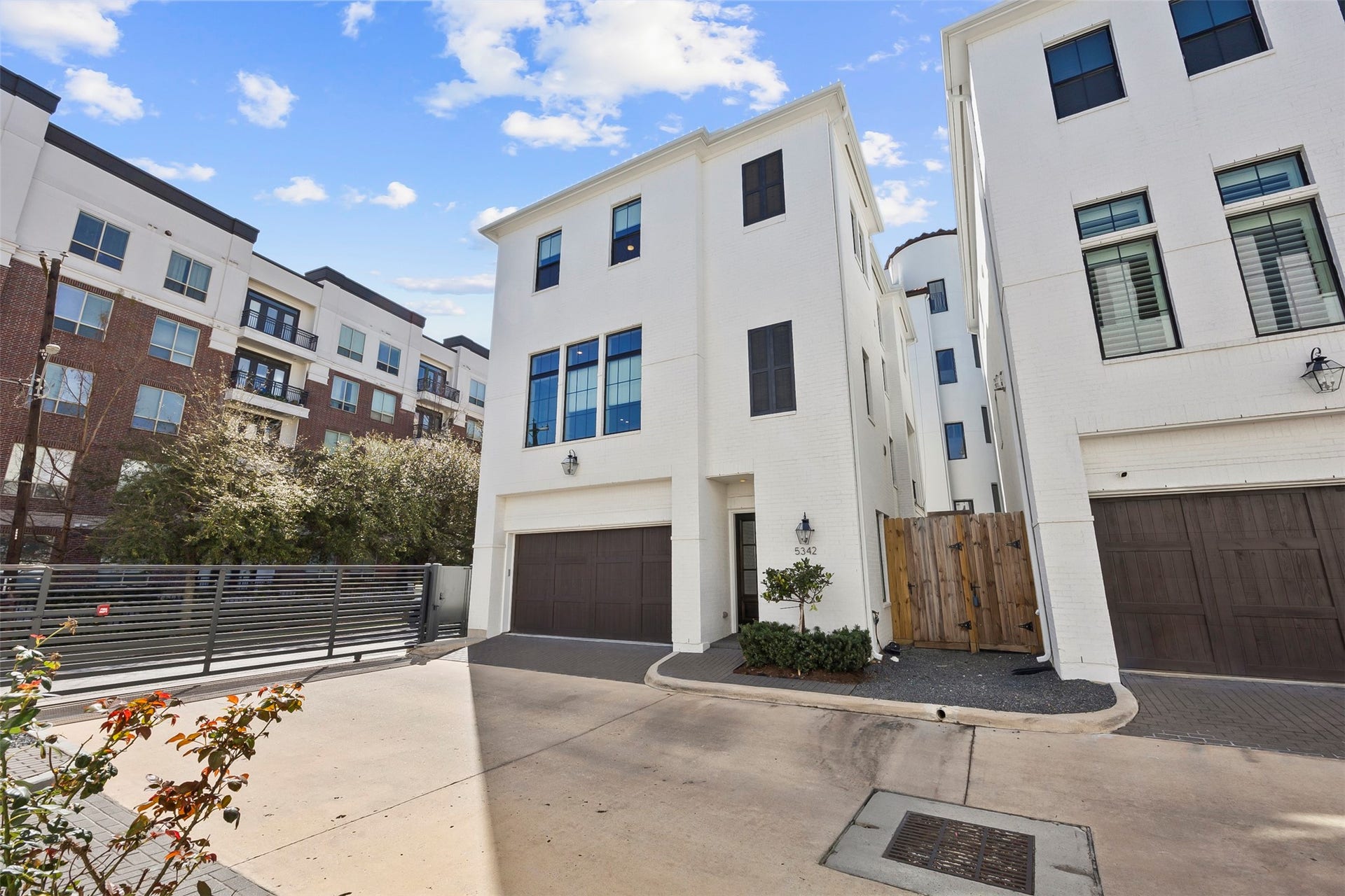 Gated private driveway leading to the attached three-car tandem garage, providing additional privacy and convenience.