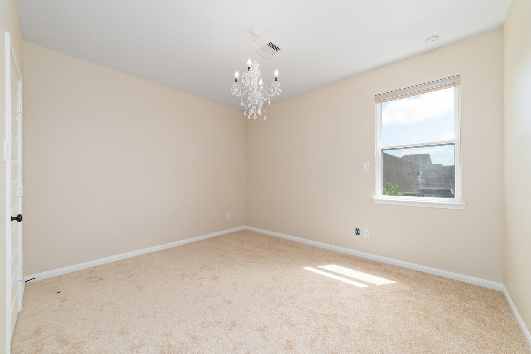 17302 Milrig Court, Richmond, TX 77407 Experience comfort and elegance in Bedroom #5, featuring plush carpeting, a chic chandelier, and abundant natural light.
