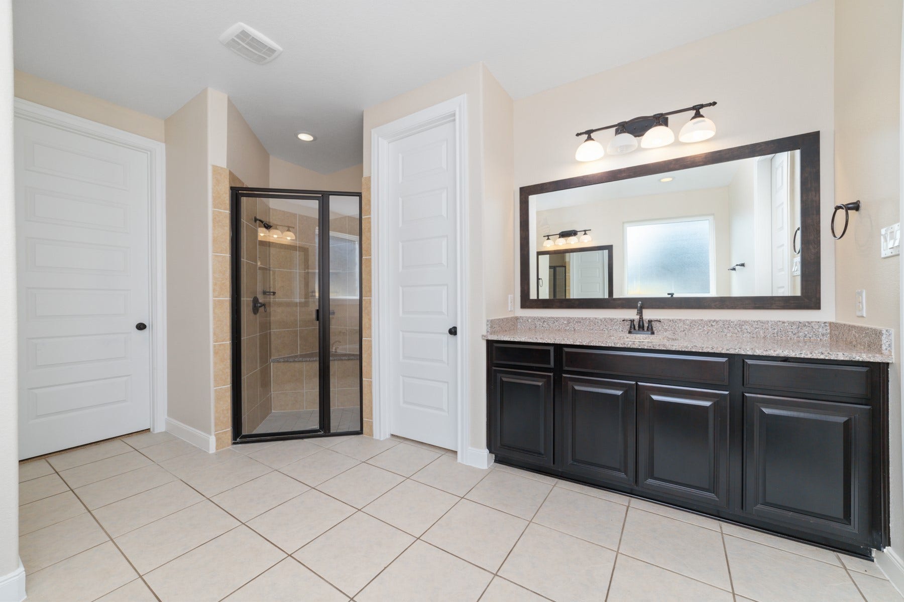 17302 Milrig Court, Richmond, TX 77407 Experience luxury in the primary bathroom featuring a sleek mud set standing shower, complemented by elegant finishes and ample space for relaxation.