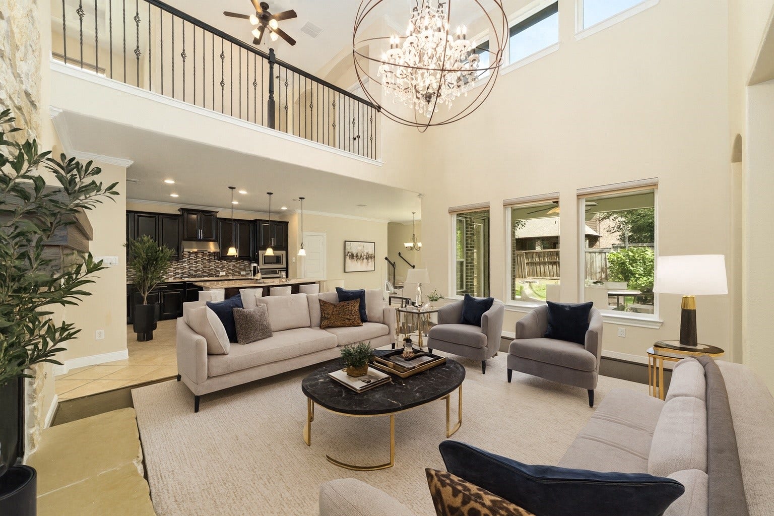 17302 Milrig Court, Richmond, TX 77407 *virtually staged* - Experience the elegance of this virtually staged, spacious open-concept living area, featuring soaring ceilings, abundant natural light, and a stunning modern chandelier, seamlessly flowing into a sleek kitchen perfect for entertaining.