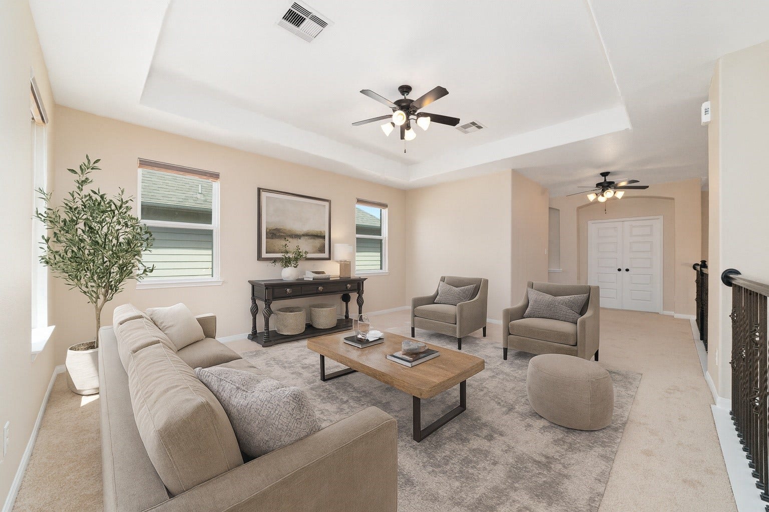 17302 Milrig Court, Richmond, TX 77407 *virtually staged* - Elegant and inviting living area with plush seating, a stylish coffee table, and abundant natural light, perfect for cozy gatherings.