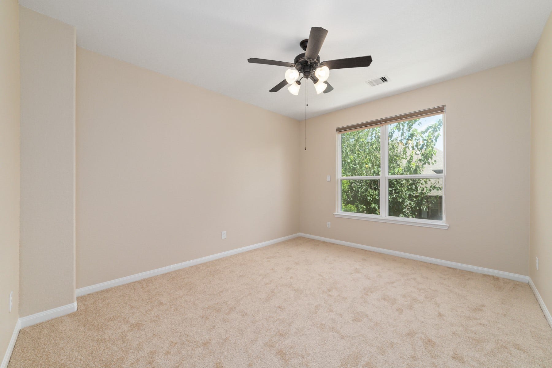 17302 Milrig Court, Richmond, TX 77407 Upstairs awaits a versatile media room, offering a cozy, light-filled space perfect for entertainment and relaxation.