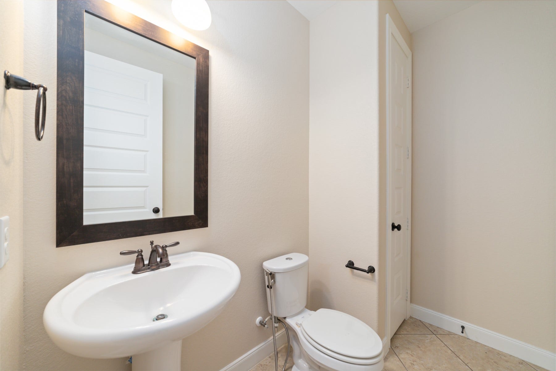 17302 Milrig Court, Richmond, TX 77407 Elegant and functional, the downstairs powder room features modern fixtures and sleek design, perfect for guests and everyday convenience.