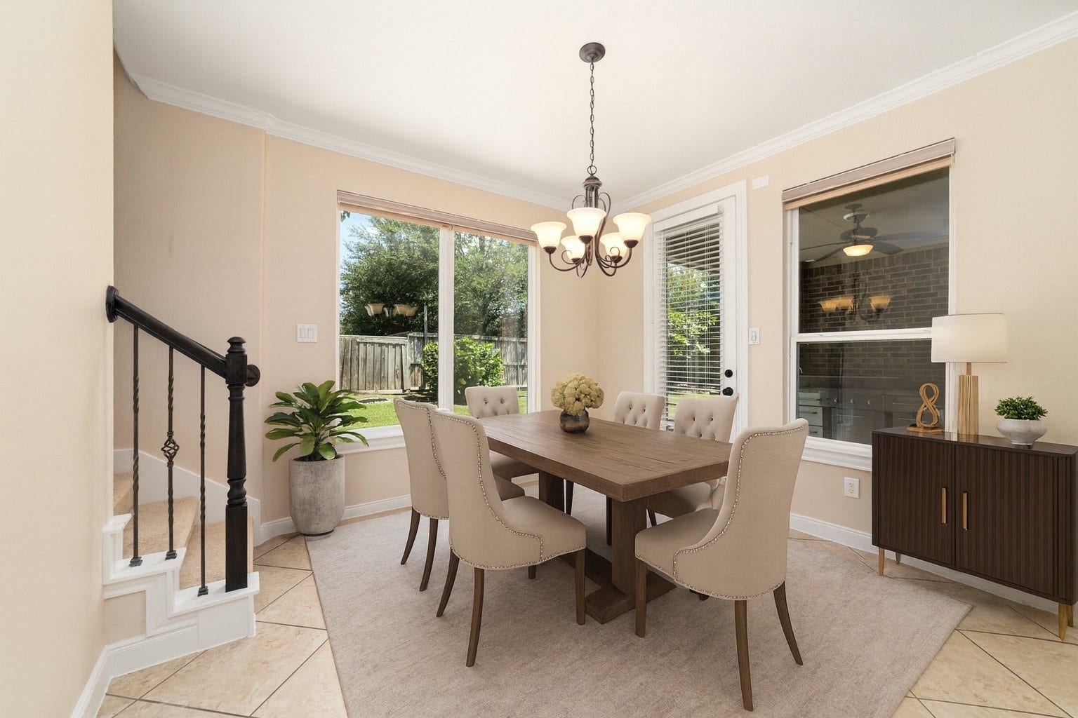 17302 Milrig Court, Richmond, TX 77407 *virtually staged* - Experience elegant dining in a sunlit room with modern furnishings to showcase its inviting ambiance and charm.