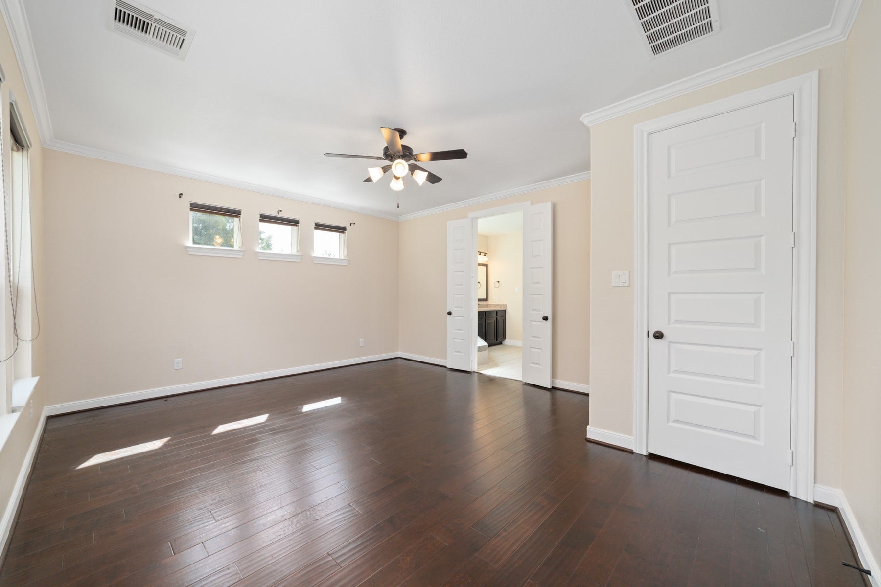 17302 Milrig Court, Richmond, TX 77407 Spacious and inviting, the main primary room downstairs features elegant hardwood floors, abundant natural light, and direct access to a luxurious ensuite, creating a perfect retreat.