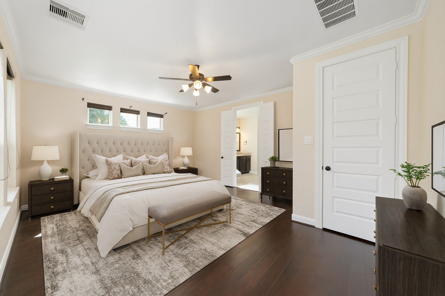 17302 Milrig Court, Richmond, TX 77407 *virtually staged* - Experience the elegance of this bedroom, featuring a plush tufted headboard, rich hardwood floors, and abundant natural light, creating a serene and inviting retreat.