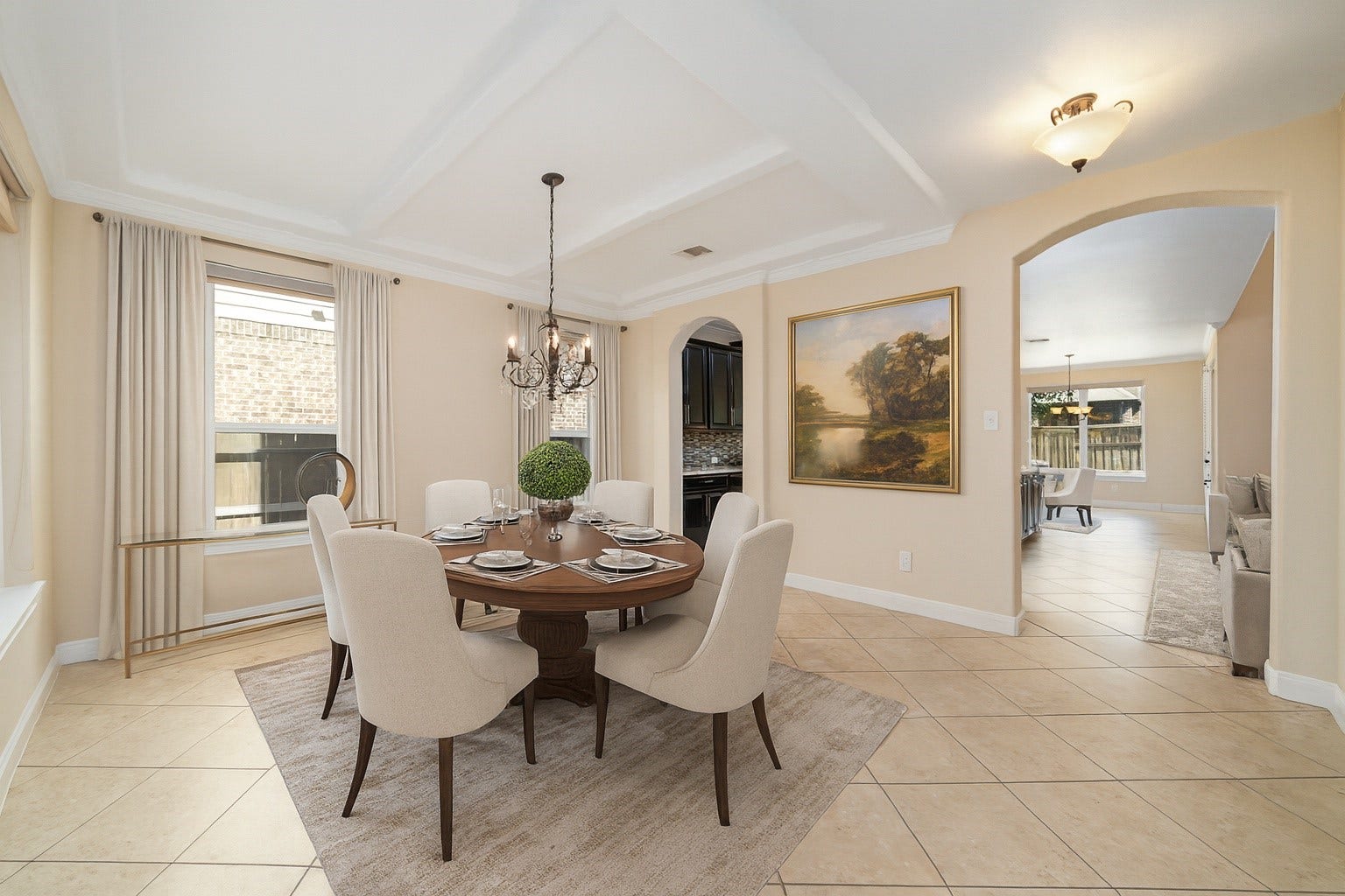 17302 Milrig Court, Richmond, TX 77407 *virtually staged* - Experience elegance in this dining room, featuring a sophisticated chandelier, ample natural light, and seamless flow into the inviting living area.