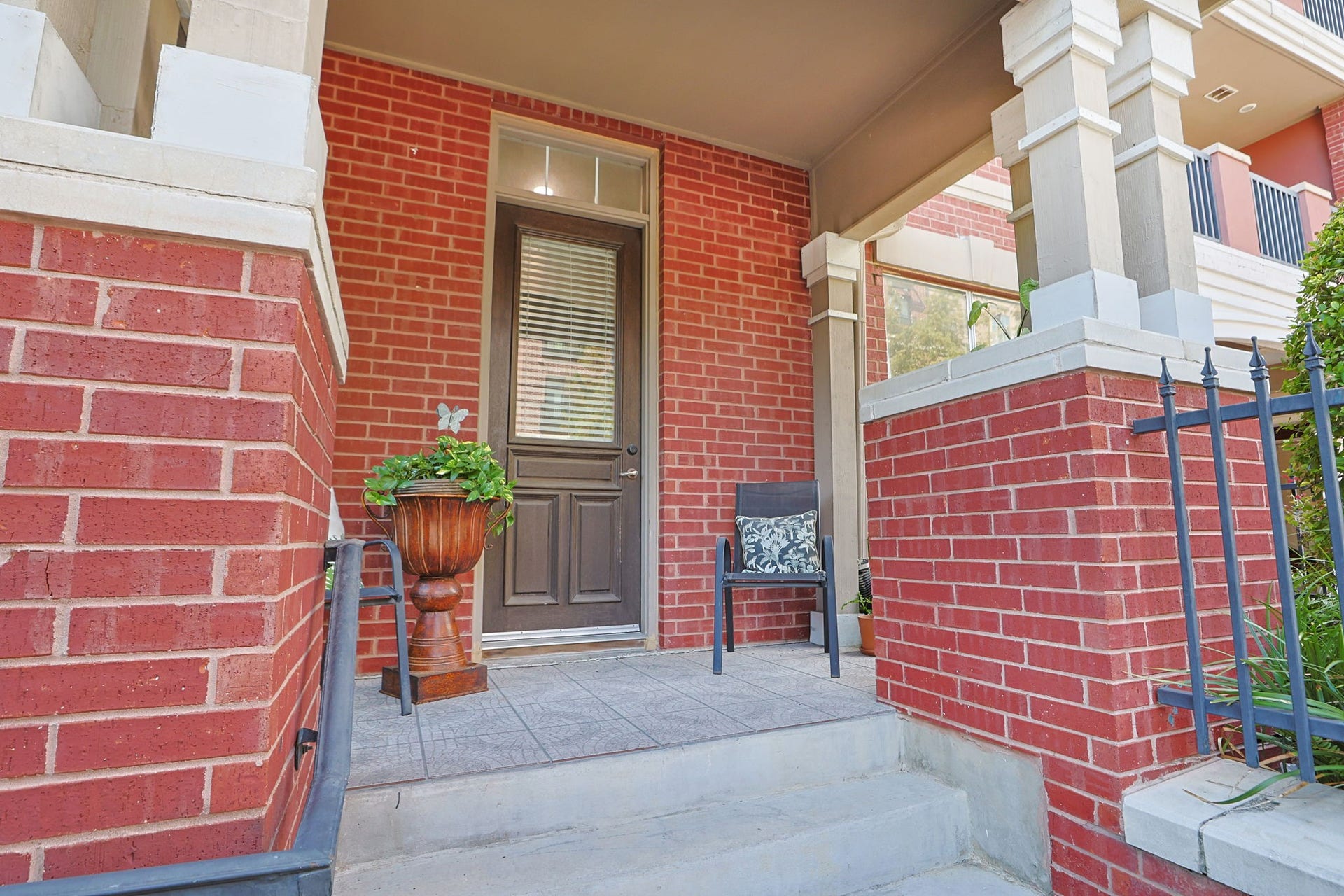 2400 S Mccue Road, #104, Houston, TX 77056 Charming condo entry from McCue Street features a spacious patio perfect for relaxation and welcoming guests.