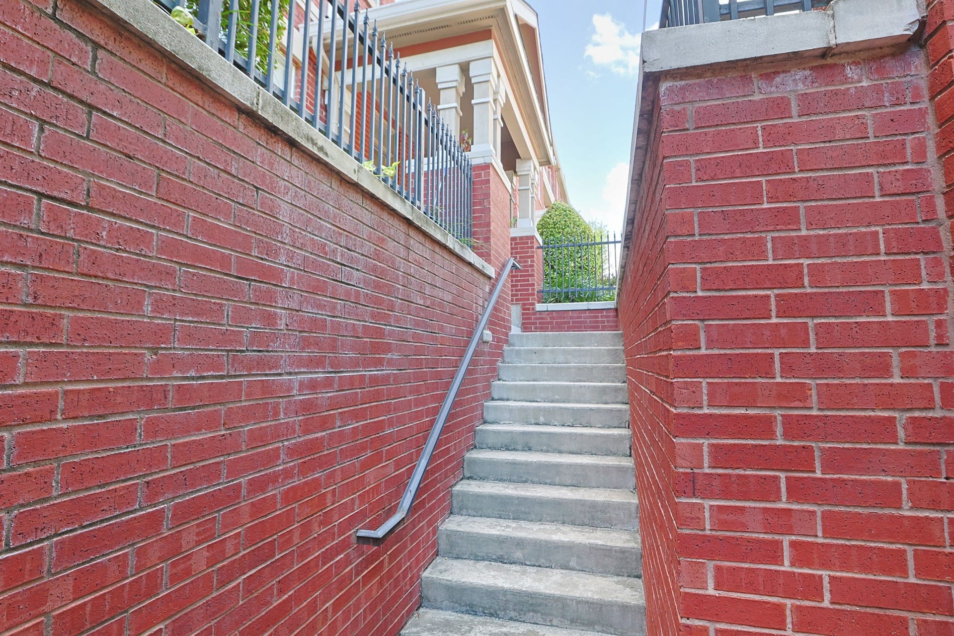 2400 S Mccue Road, #104, Houston, TX 77056 Ascend the inviting brick-lined staircase to discover your charming condo just beyond the left of the landing.