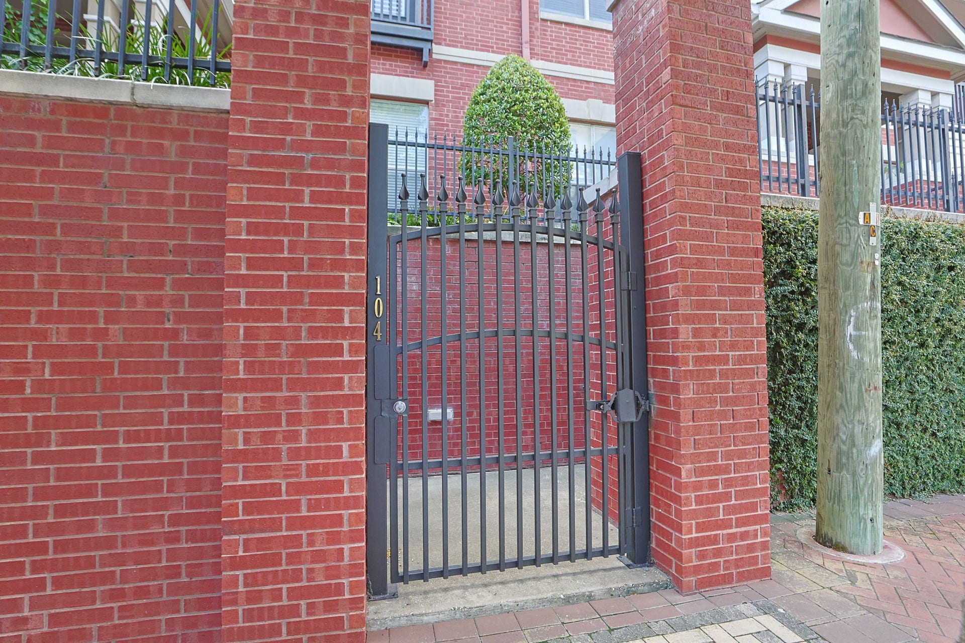 2400 S Mccue Road, #104, Houston, TX 77056 Charming condo entrance located on McCue Street, offering a welcoming pedestrian gate right from the sidewalk.