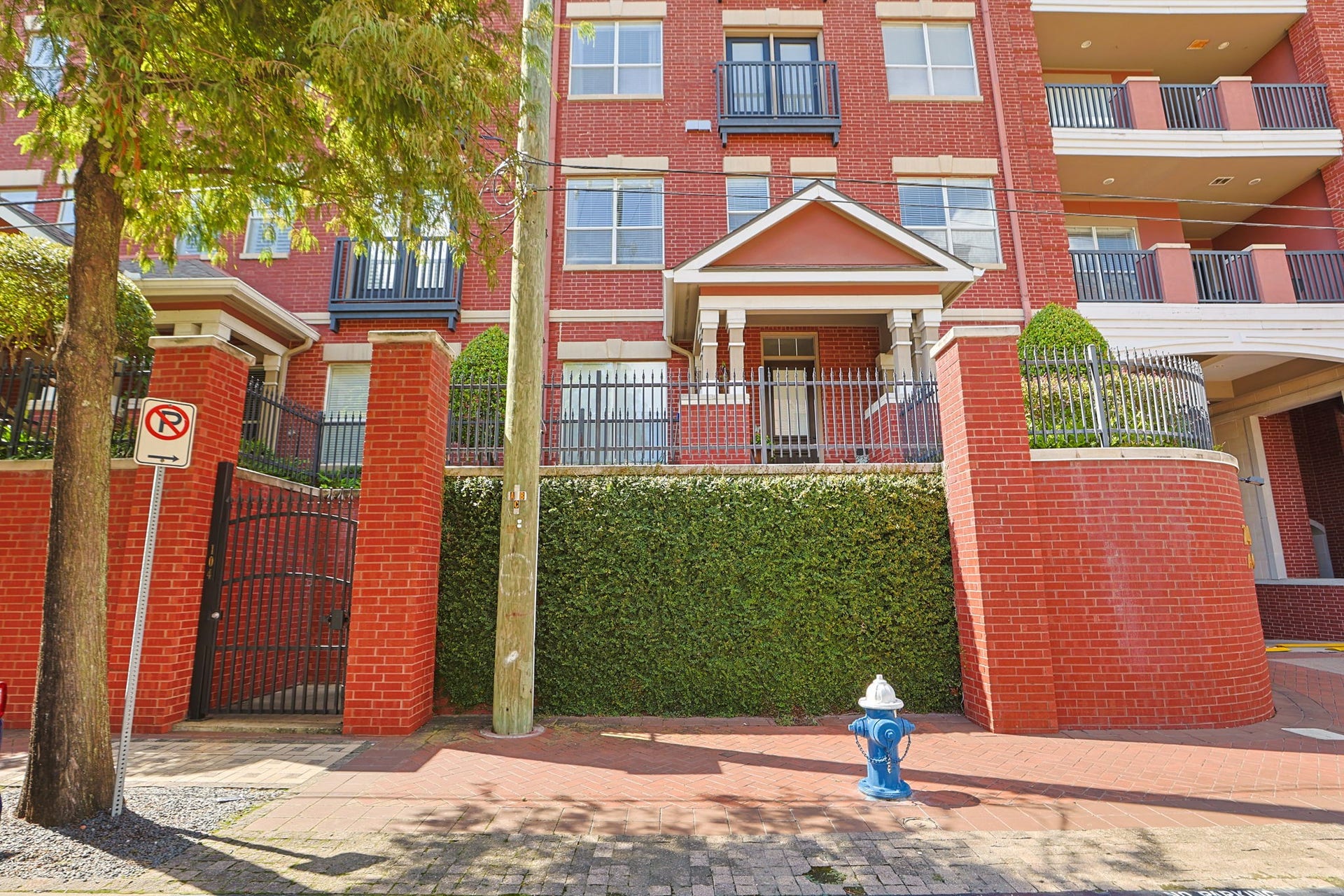 2400 S Mccue Road, #104, Houston, TX 77056 Charming condo entrance from McCue Street features a welcoming pedestrian gate leading to your new home.