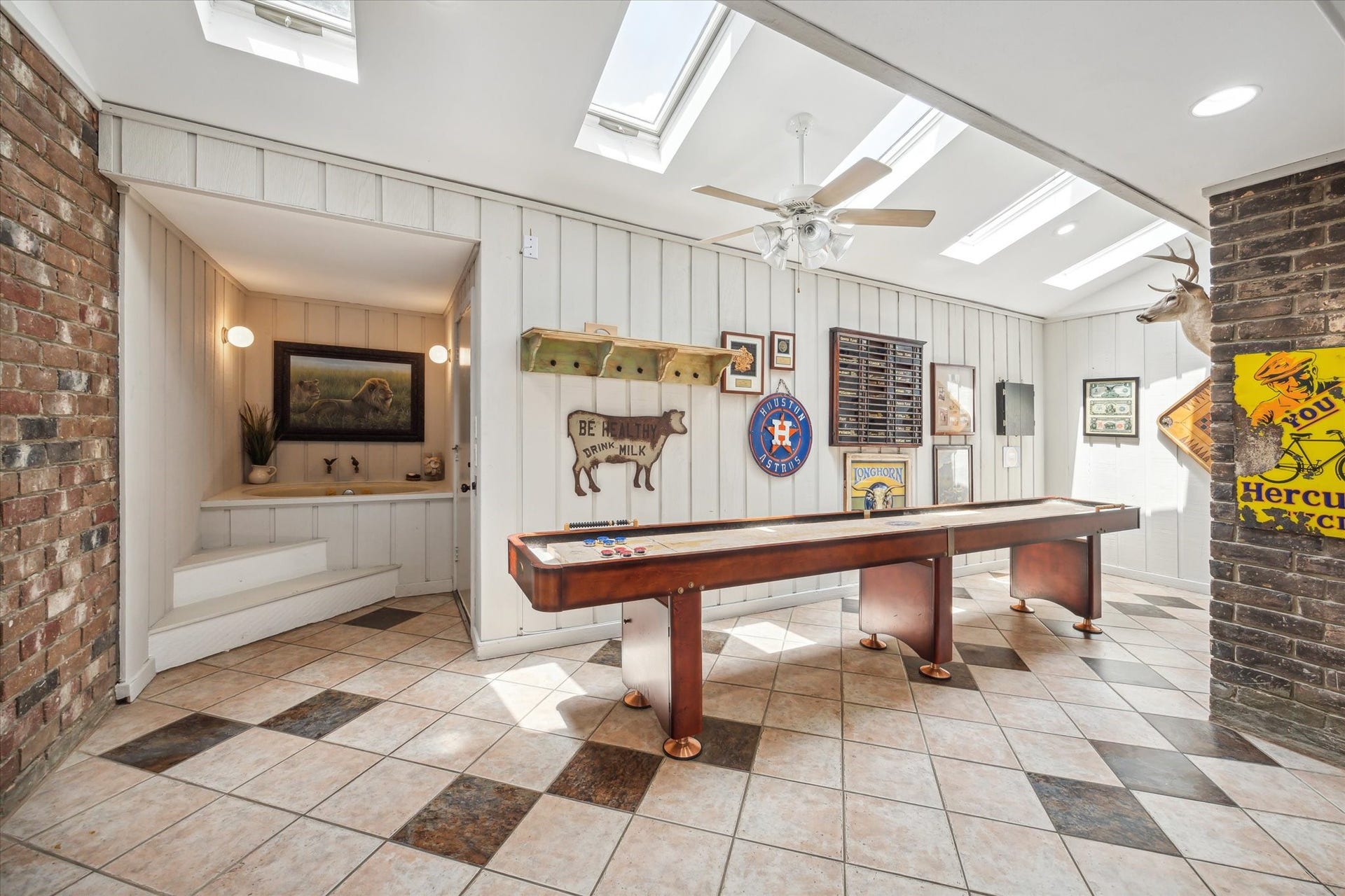 Game room, was enclosed by a previous owner.  Skylights and a small hot tub frame this fun room.