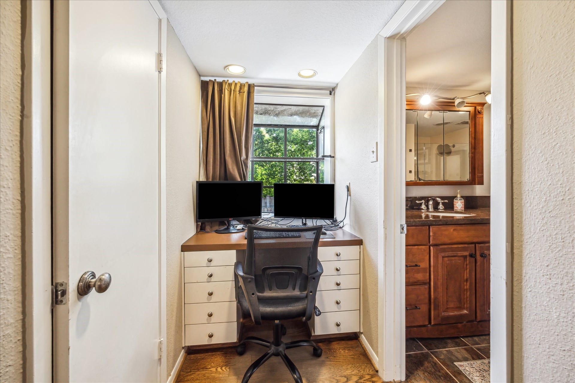 Small desk area resides by the ensuite bath.