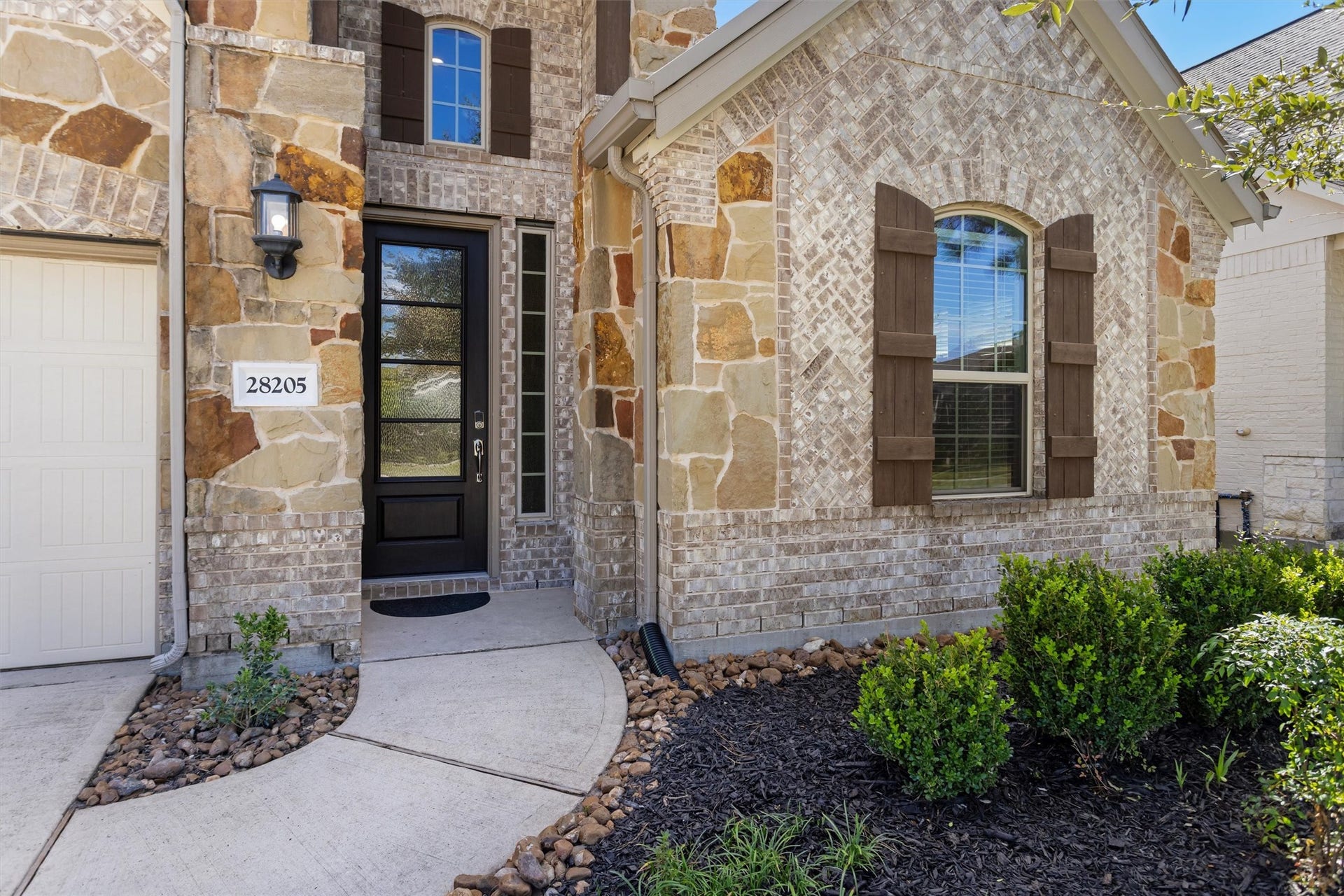 28205 Bennett Pass Drive, Spring, TX 77386 Covered front porch entry. Great curb appeal with brick and stone facade
