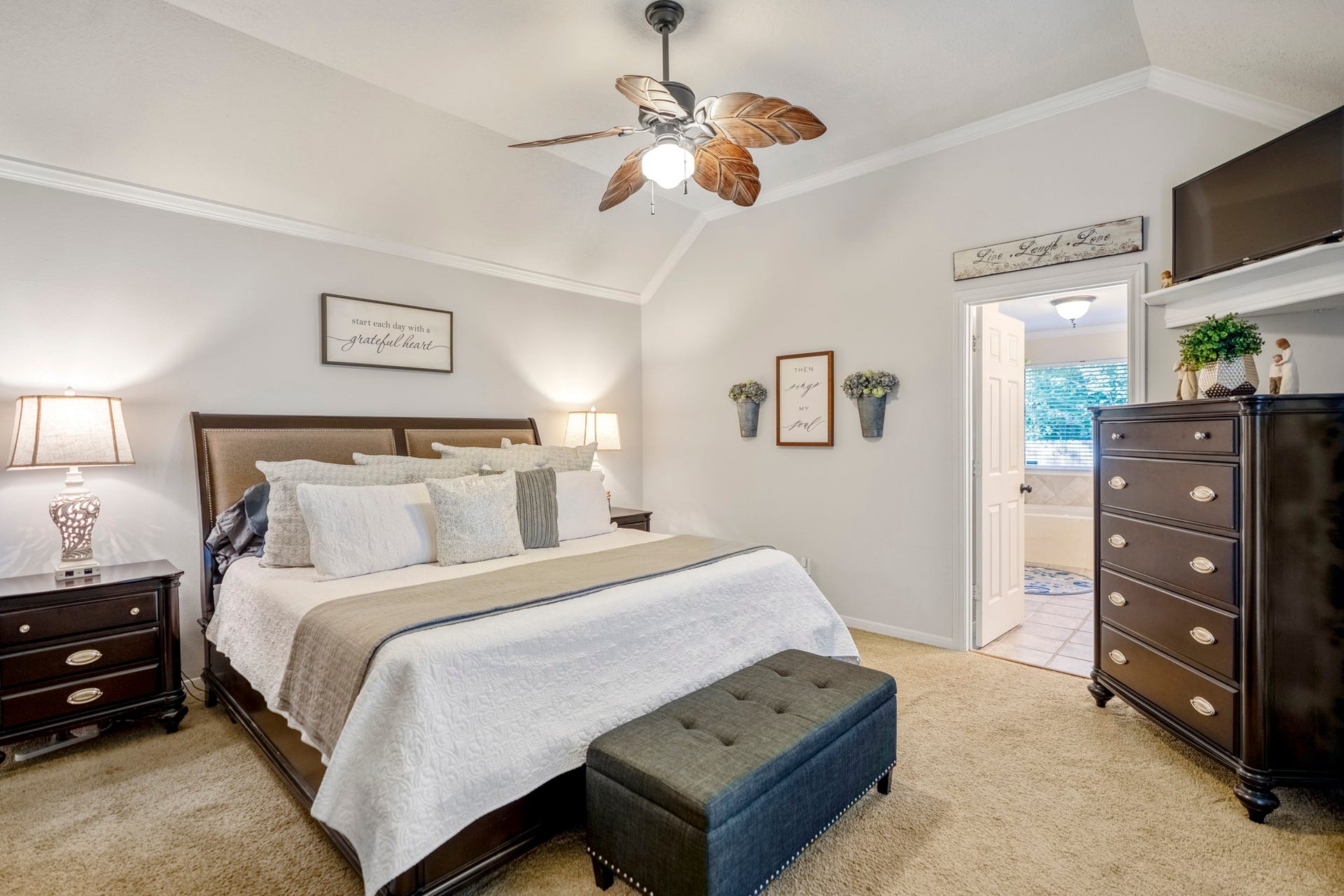 812 Woodland Lane, Conroe, TX 77302 Spacious primary suite features a vaulted ceiling, crown molding and private bath access.