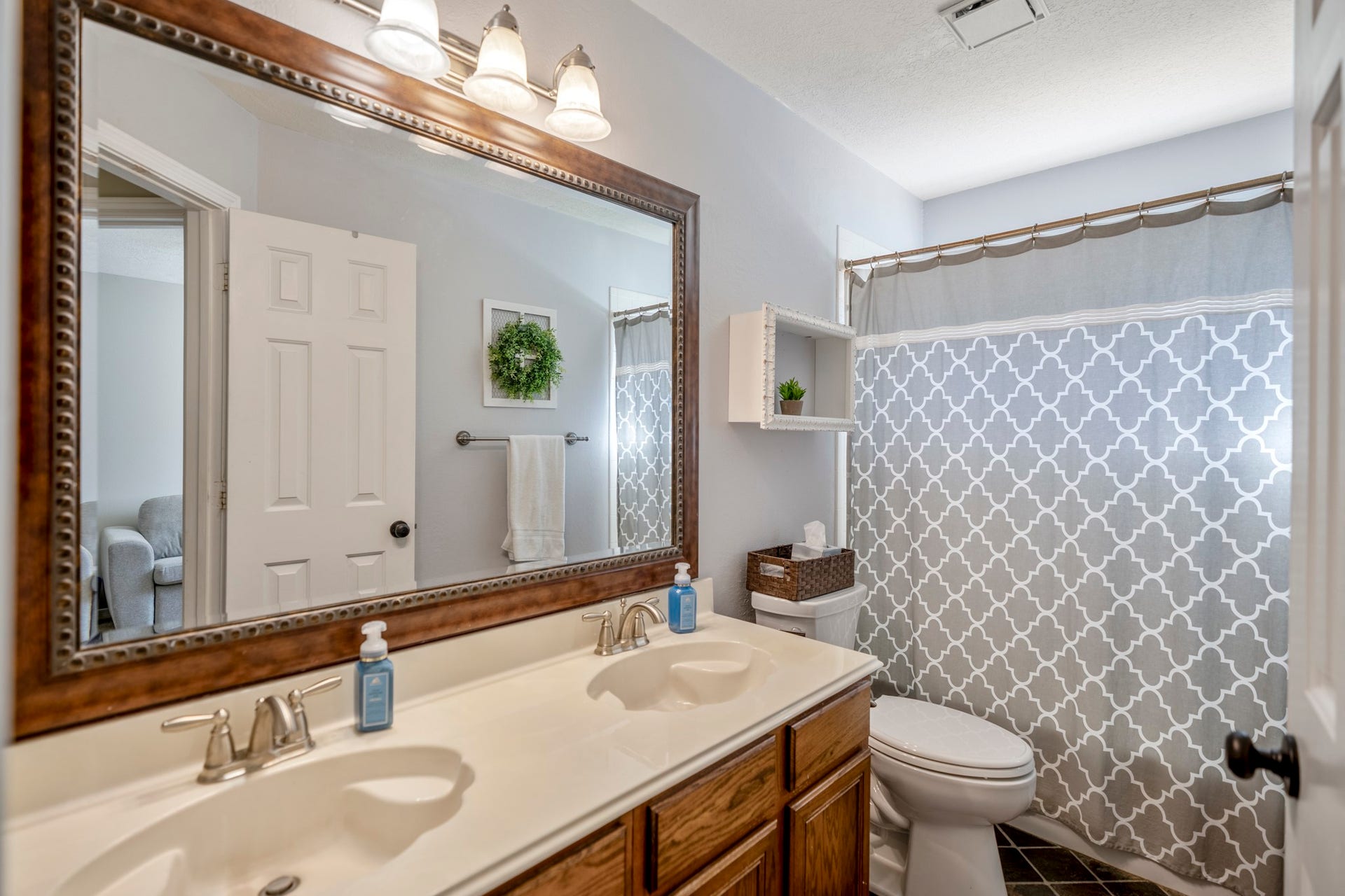 812 Woodland Lane, Conroe, TX 77302 Functional secondary bath with double sinksextra counter space makes busy mornings a little easier.