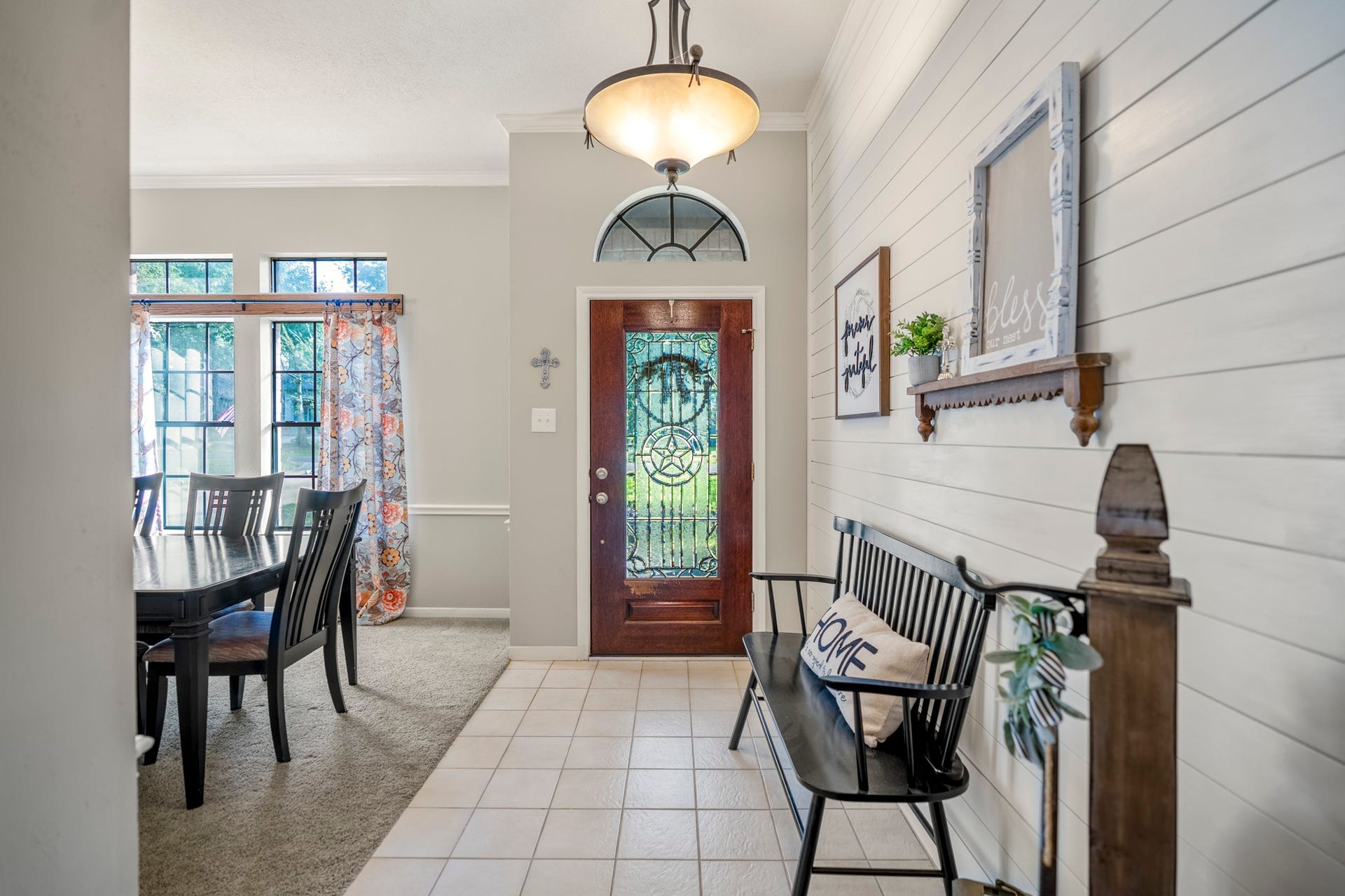 812 Woodland Lane, Conroe, TX 77302 Welcoming entry features a statement front door, transom window and shiplap accent wall.