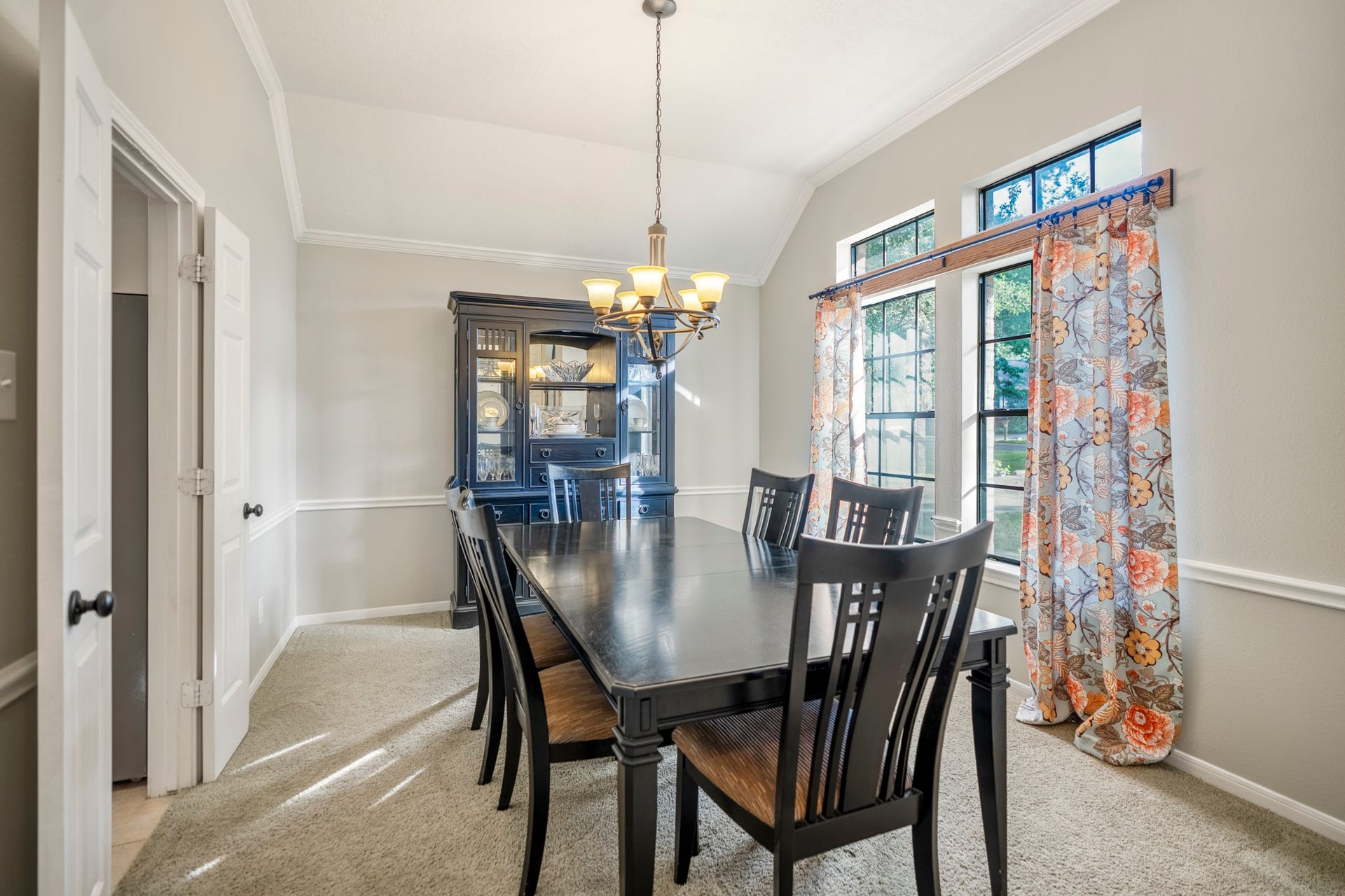 812 Woodland Lane, Conroe, TX 77302 Light-filled formal dining room with vaulted ceiling, crown molding and chair rail detailing.