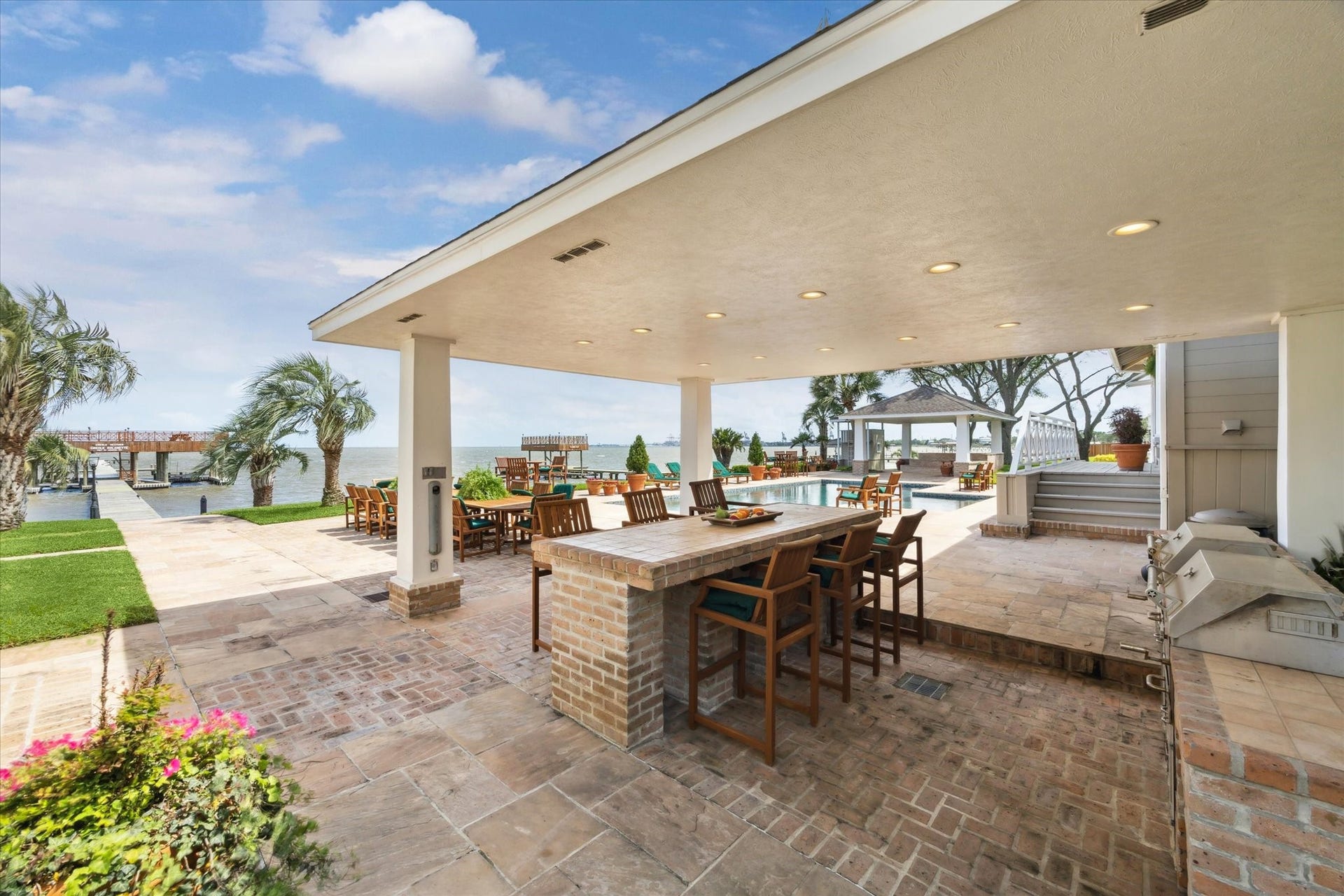 Covered dining area outside main house, adjacent to the pool.