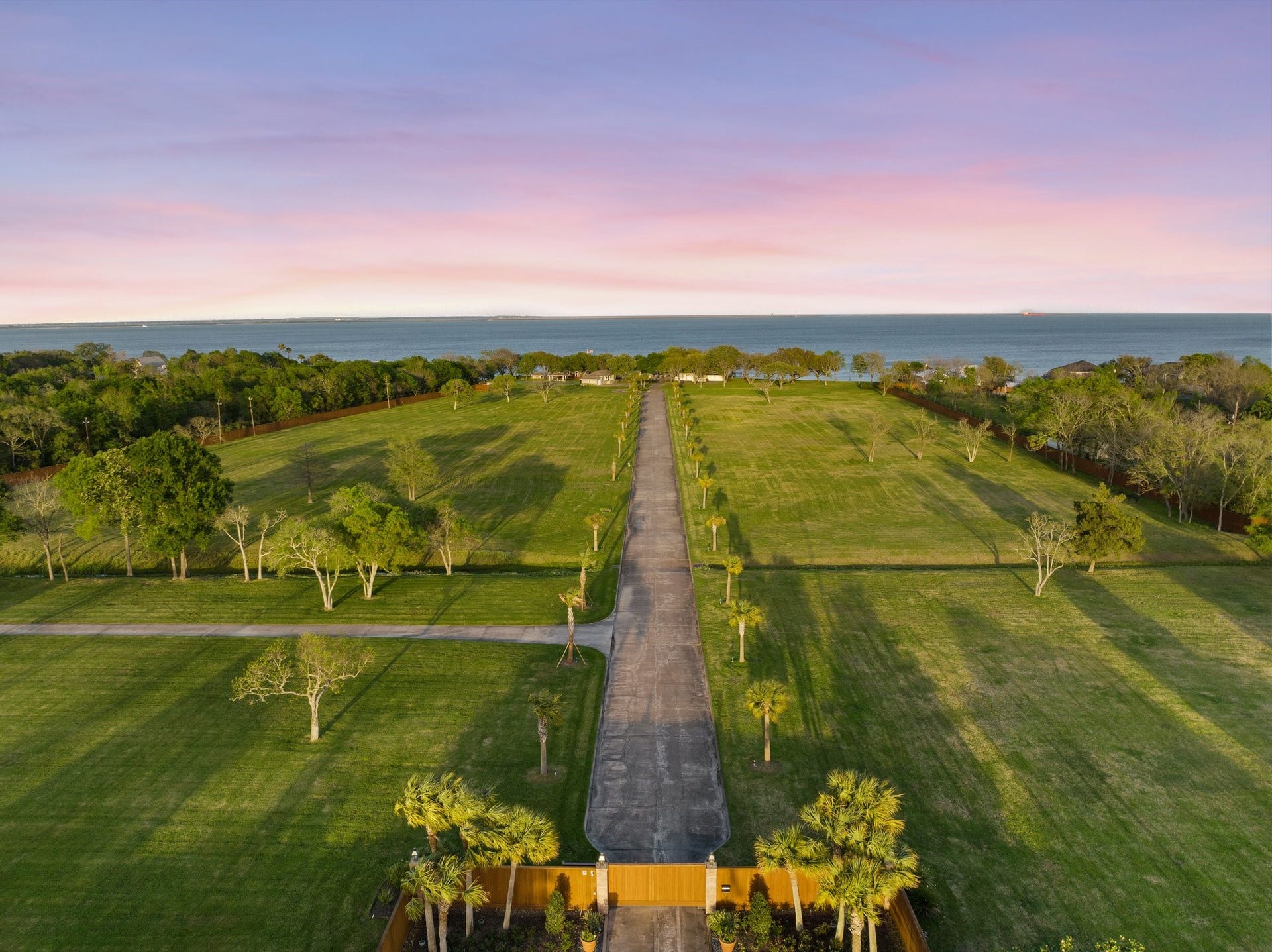 Aerial view of property at gated entrance.