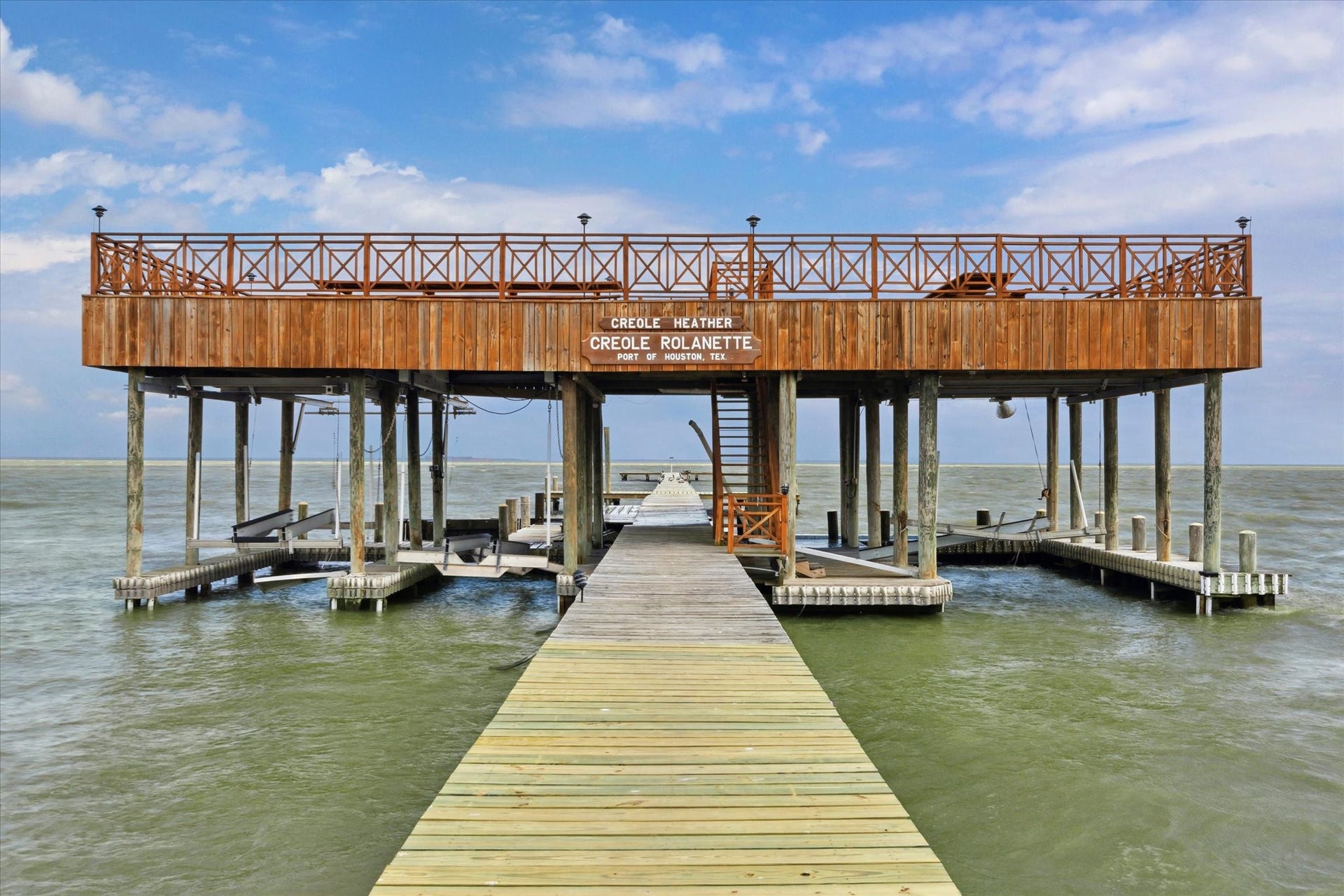 Another view of one of two of the piers, featuring raised observation, dining and entertaining deck above multiple boat slips.