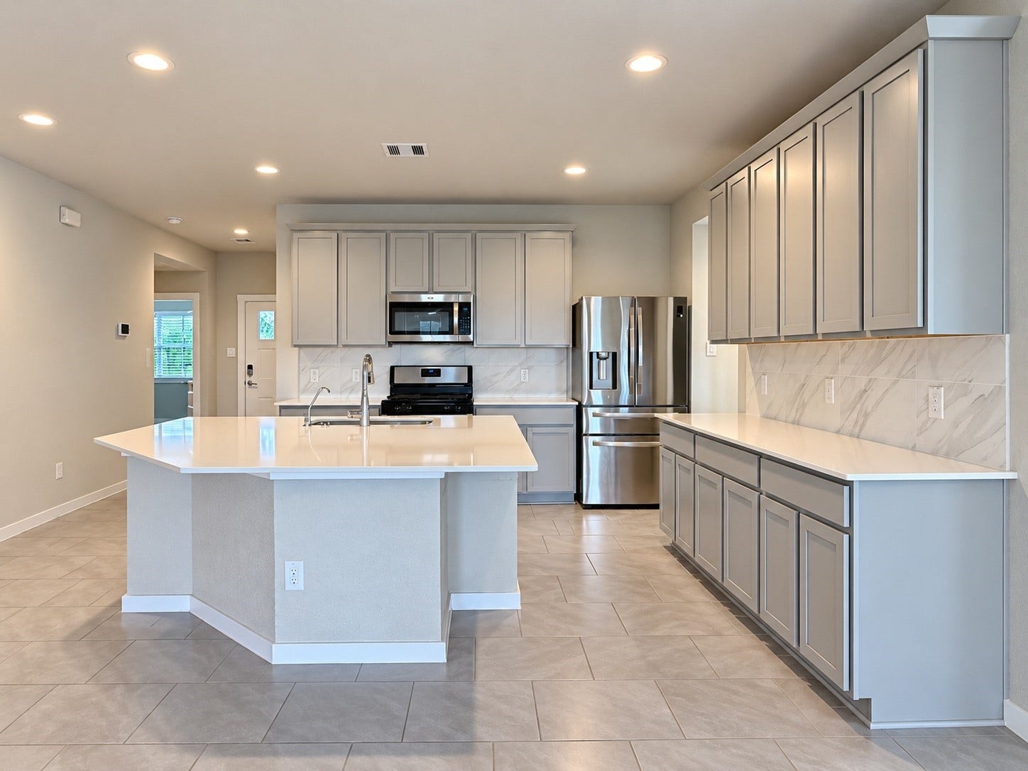 29443 Bryans Manor, Fulshear, TX 77494 Another view of the beautifully designed kitchen showcasing generous countertop space, ample cabinetry, and an open layout ideal for everyday living and entertaining.