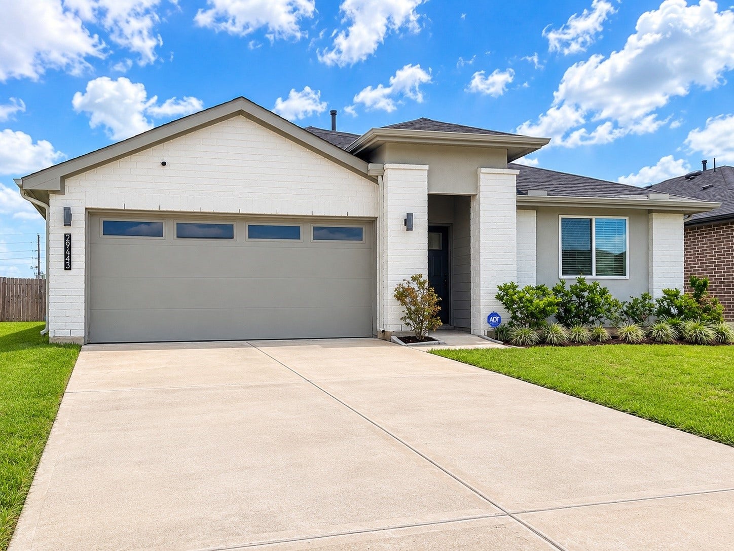 29443 Bryans Manor, Fulshear, TX 77494 Enjoy the attractive combination of brick and siding, spacious driveway, and neatly landscaped front yard.
