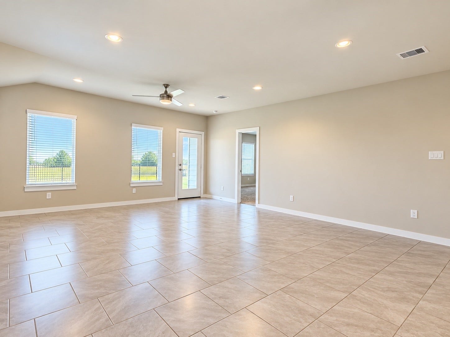 29443 Bryans Manor, Fulshear, TX 77494 Bright and spacious living area featuring beautiful tile flooring, recessed lighting, and multiple windows allowing natural light to fill the space.