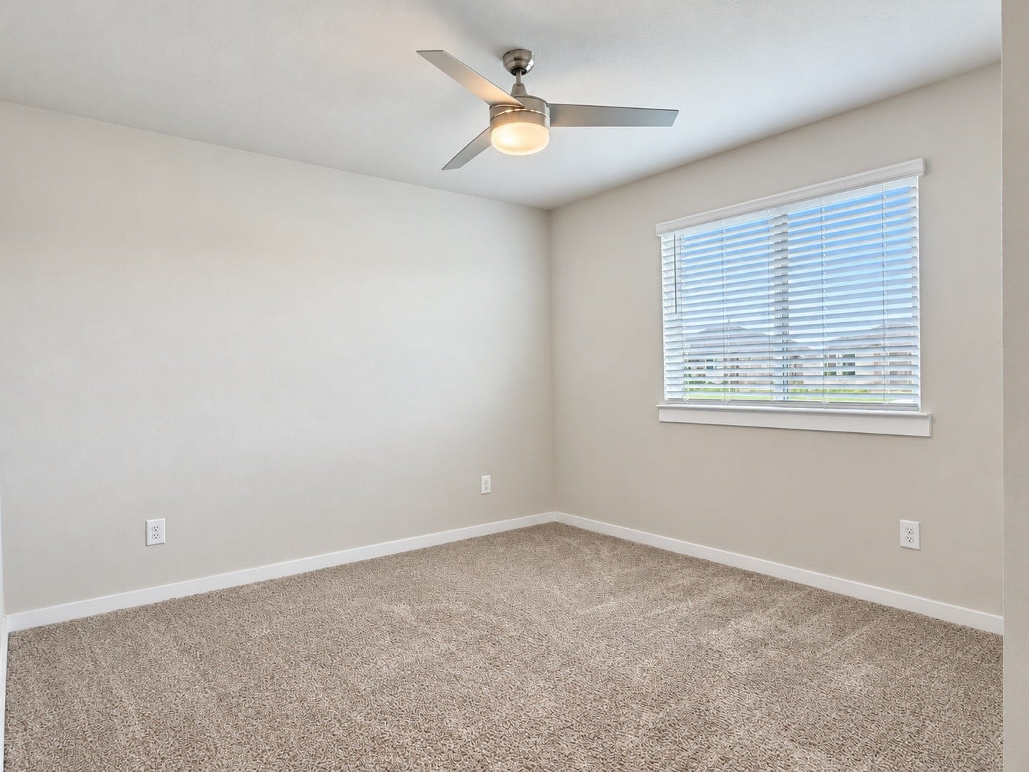 29443 Bryans Manor, Fulshear, TX 77494 Comfortable secondary bedroom featuring plush carpeting, a ceiling fan with lighting, neutral paint tones, and a window providing natural light.