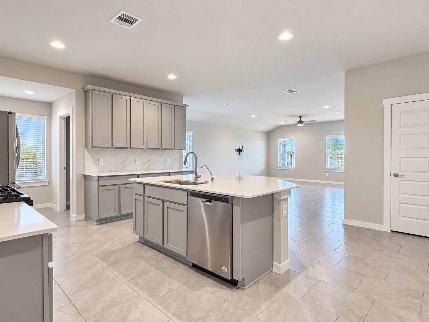 29443 Bryans Manor, Fulshear, TX 77494 Spacious kitchen featuring a large center island, stainless steel appliances, ample cabinetry, and an open layout connecting to the main living area.