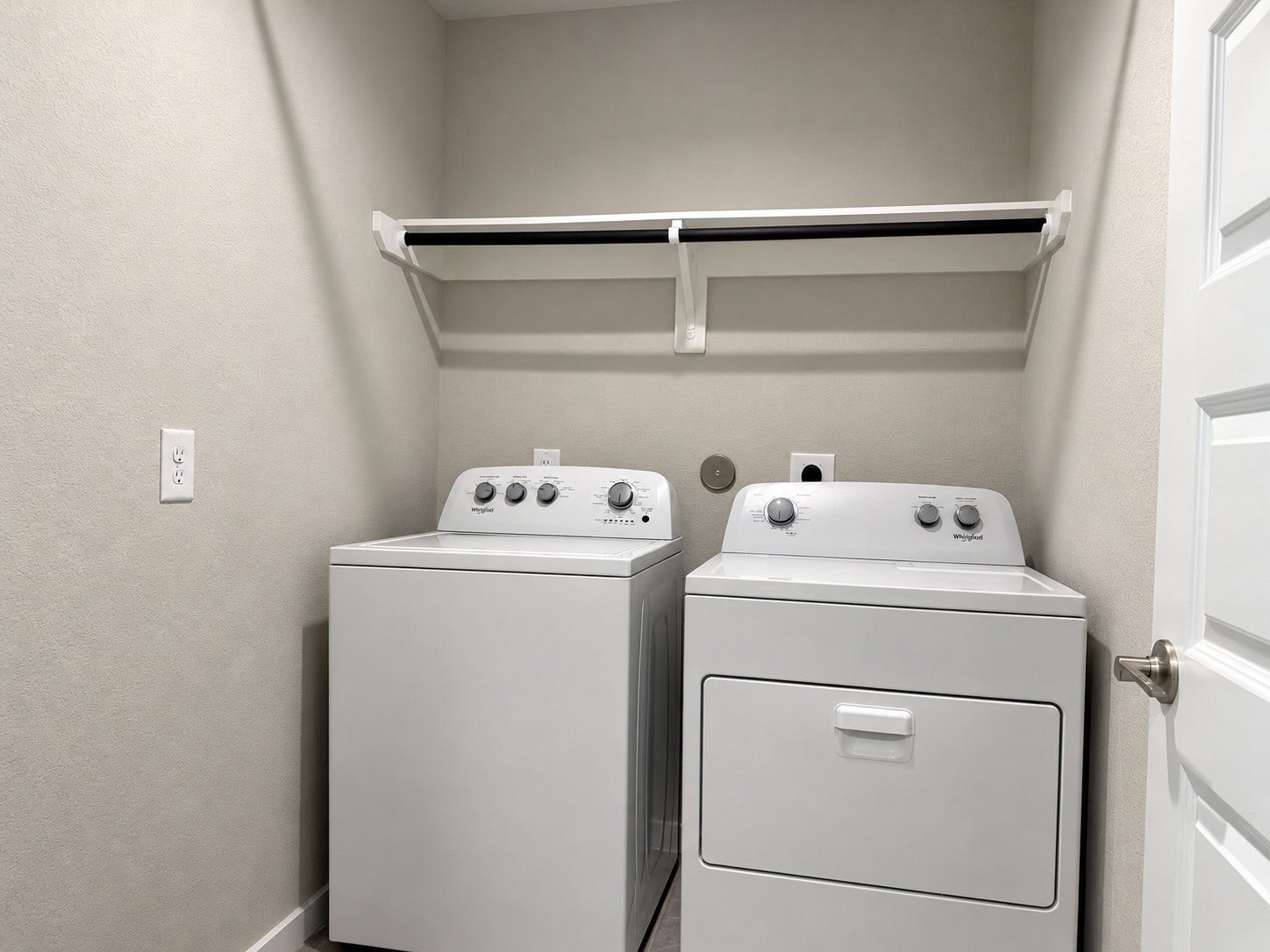 29443 Bryans Manor, Fulshear, TX 77494 Dedicated laundry room featuring a full-size washer and dryer, overhead shelving, and convenient additional storage space.