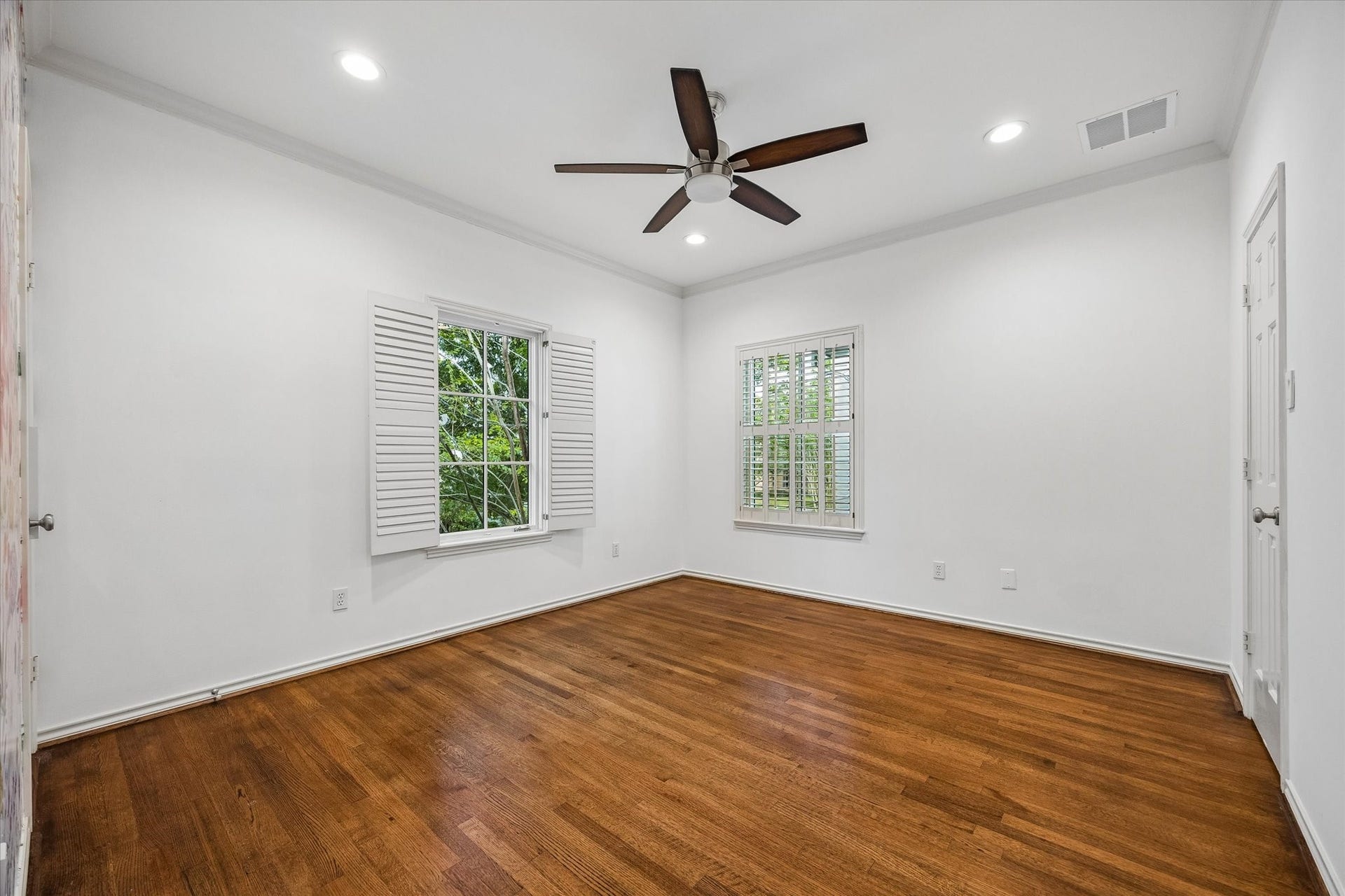 3111 Carnegie Street, Houston, TX 77005 Secondary bedroom with hardwoods, shutters, and 2026 paint.