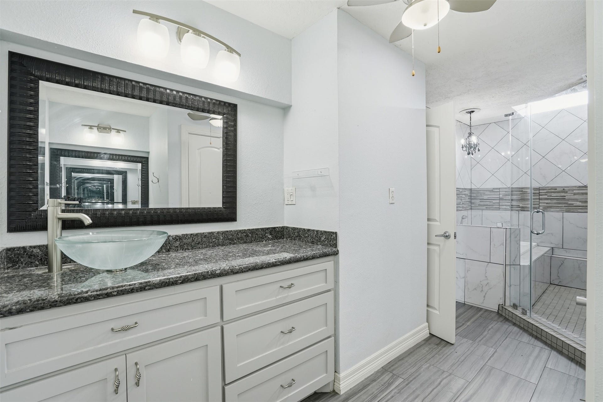 18024 Starboard Drive, Houston, TX 77058 Primary bath offers excellent storage with cabinetry beneath each vanity, providing both style and everyday convenience.
