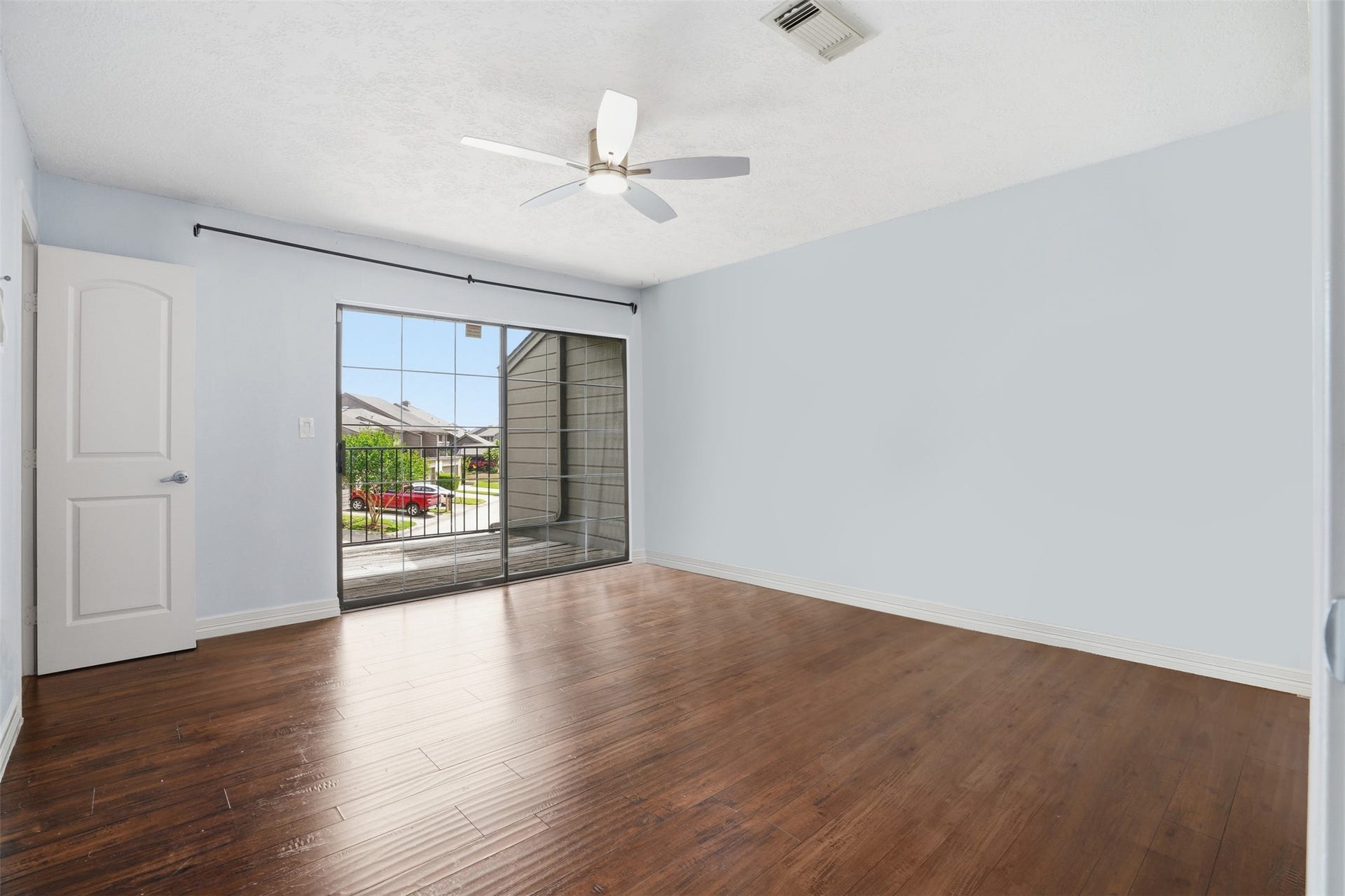 18024 Starboard Drive, Houston, TX 77058 Secondary bedroom featuring abundant natural light, an en suite bath, and access to a private balcony for your own outdoor retreat.
