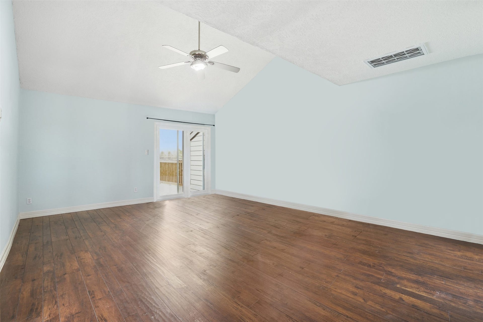 18024 Starboard Drive, Houston, TX 77058 Spacious primary suite featuring high ceilings and abundant natural light, with sliding glass doors leading to a private outdoor space.