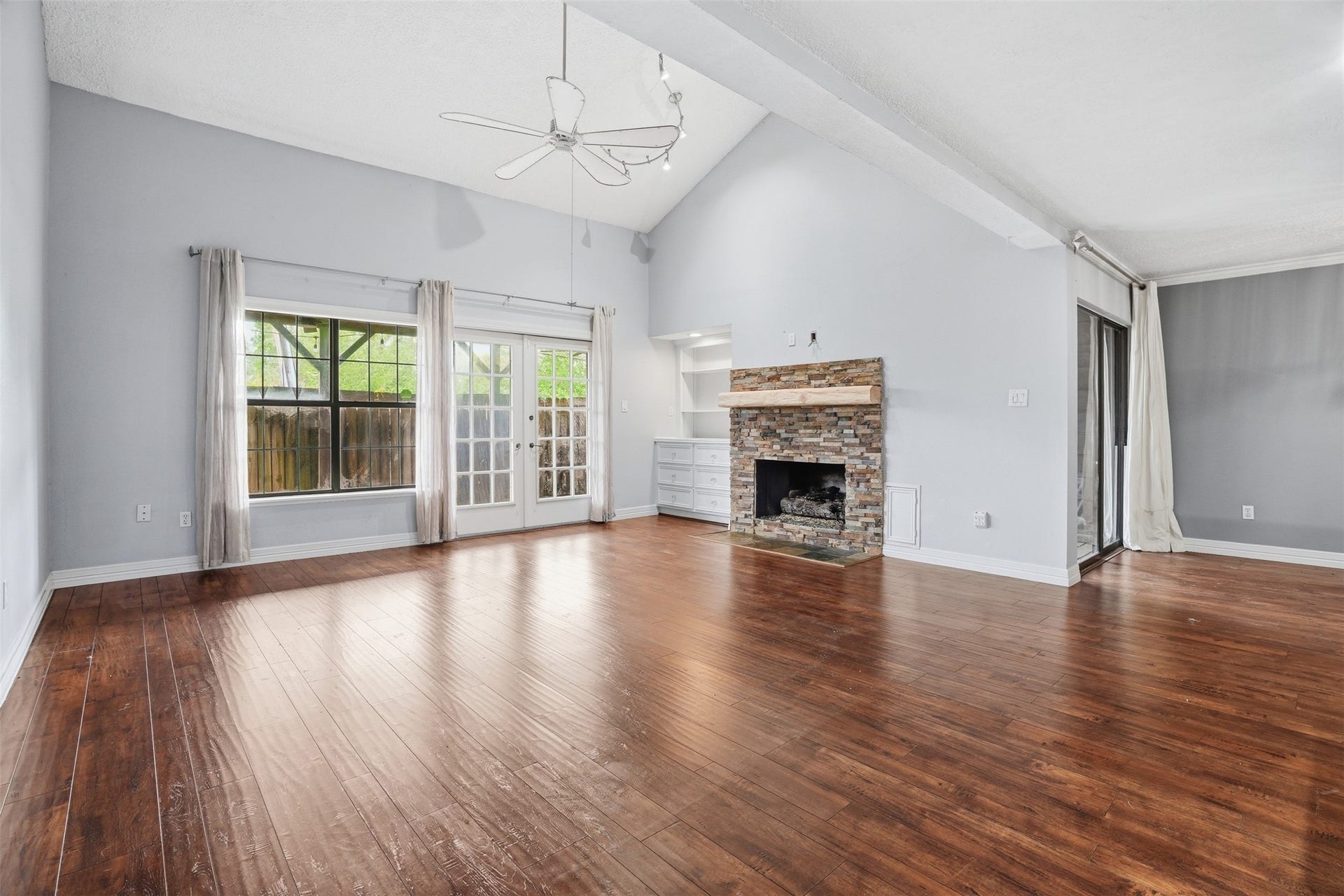18024 Starboard Drive, Houston, TX 77058 Inviting living room centered around a beautiful stone fireplace that adds warmth, character, and timeless appeal.