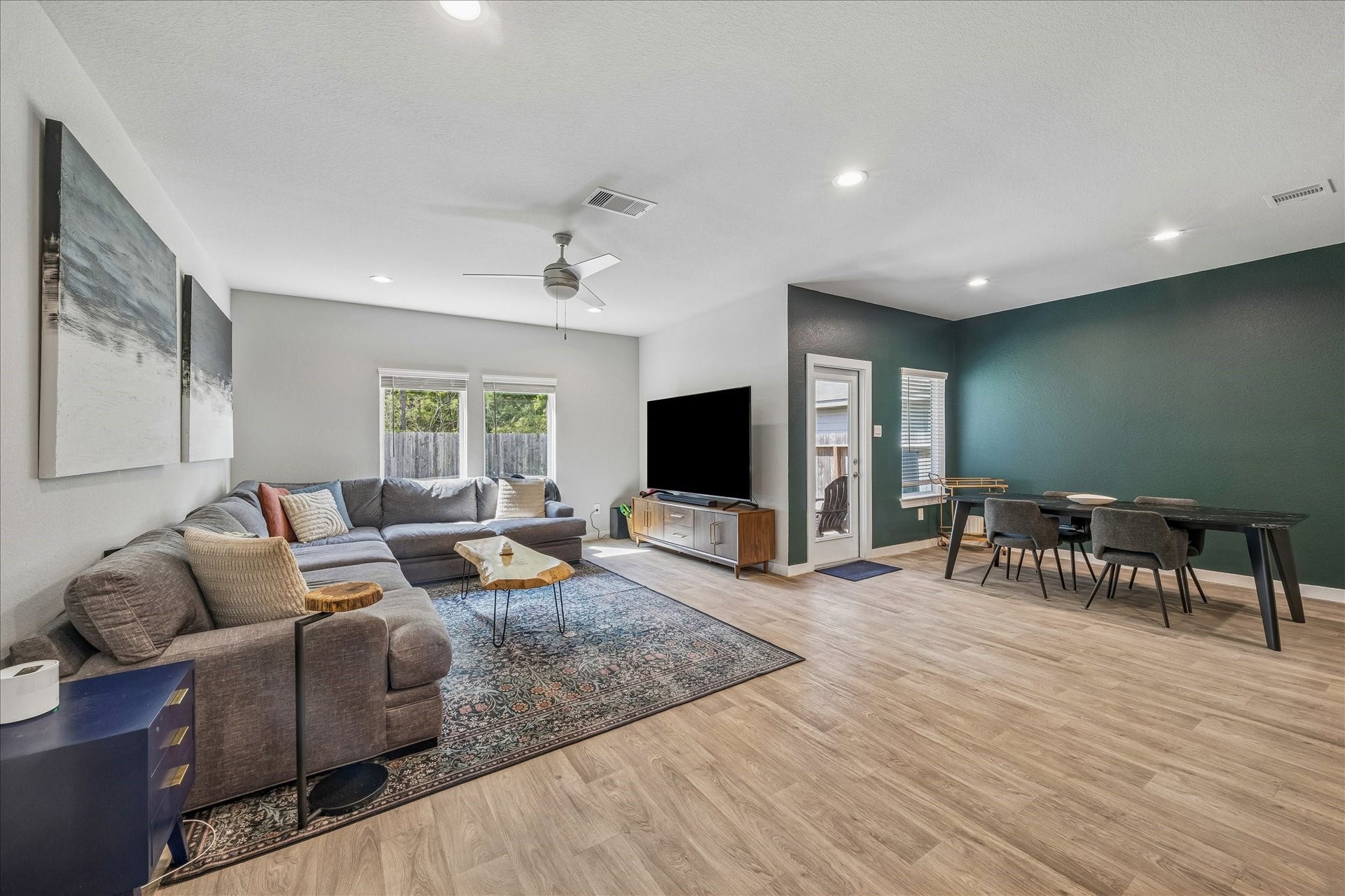 14249 Wonder Lake Lane, Conroe, TX 77384 The calming green accent wall coordinates with the lush green backdrop of trees behind the property.
