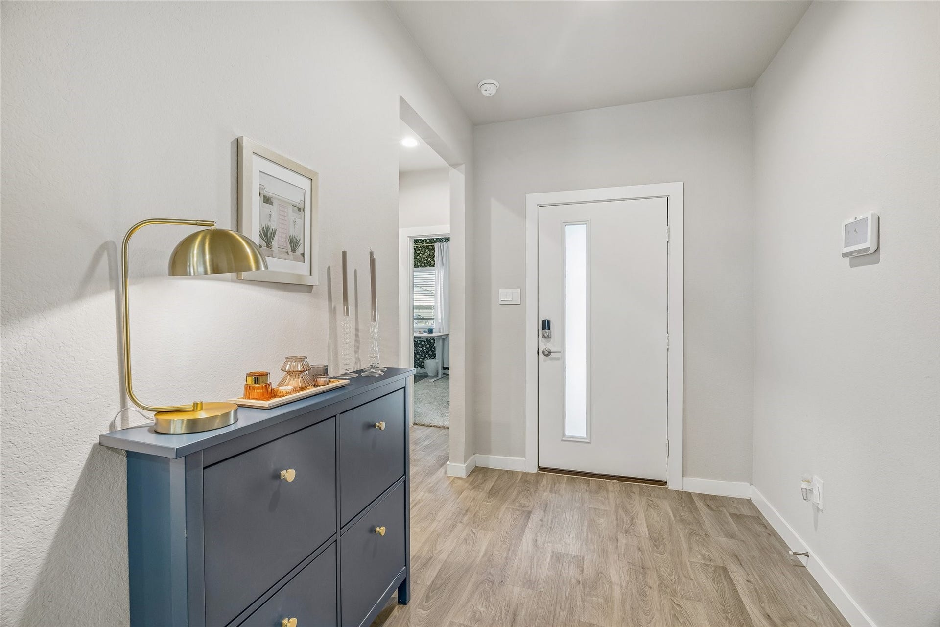 14249 Wonder Lake Lane, Conroe, TX 77384 Bright entryway with neutral vinyl plank flooring. This home features a study/optional 4 bedroom to the left.