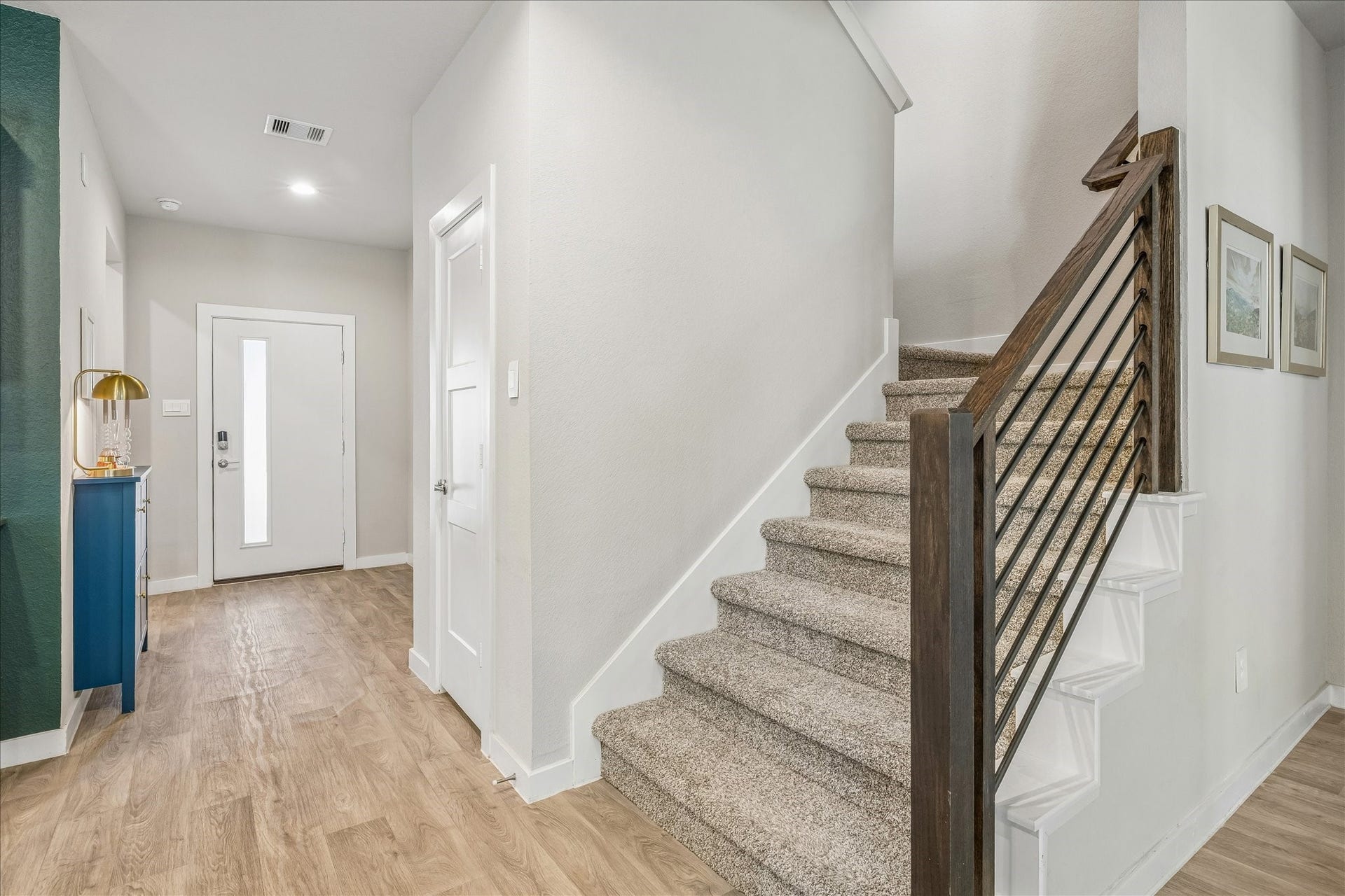 14249 Wonder Lake Lane, Conroe, TX 77384 Off the entryway is the modern staircase with wrought iron detailing.