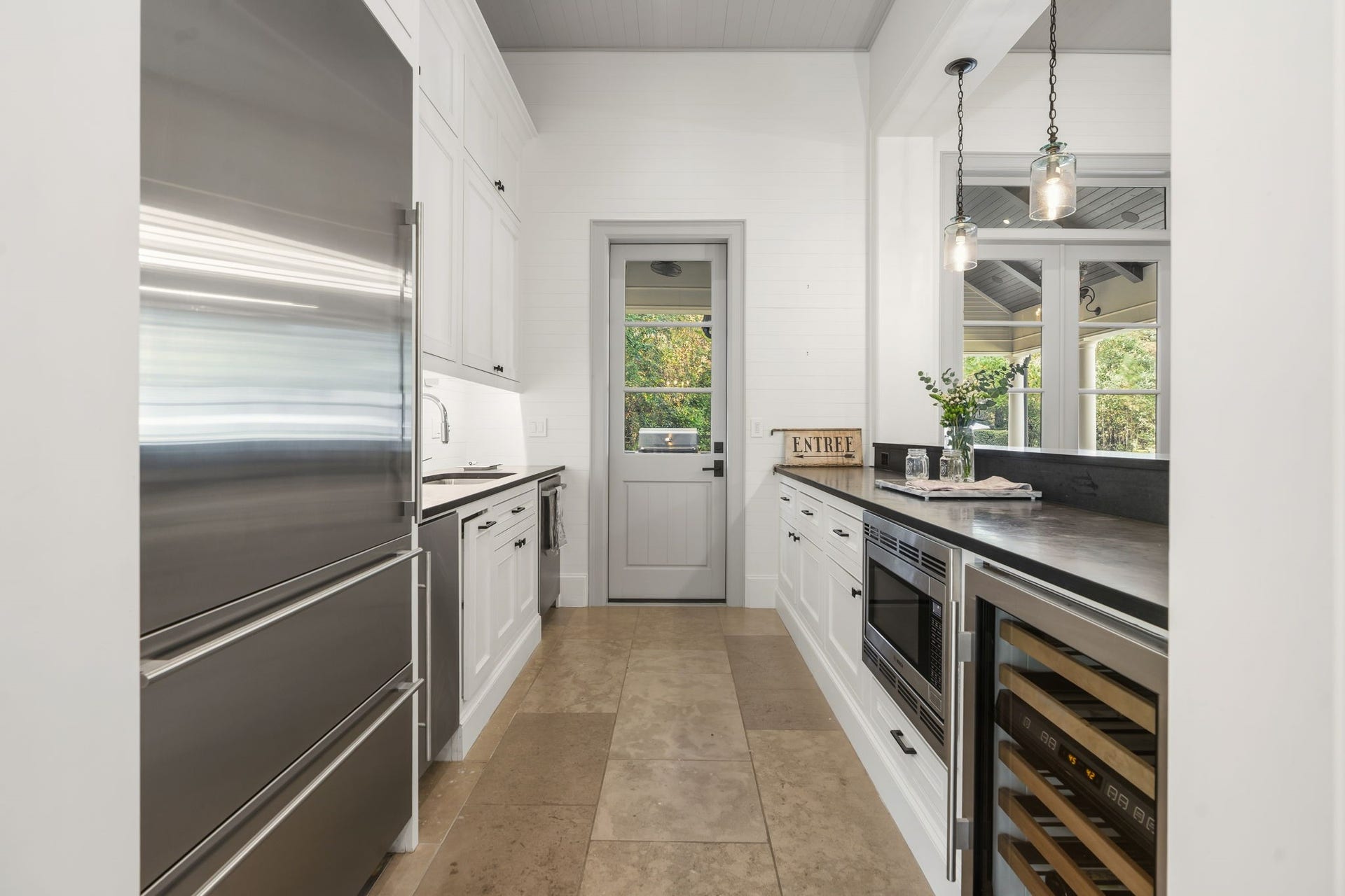 14 Peony Springs Court, The Woodlands, TX 77382 Eye-catching shiplap walls are the ideal background for a complete game/den kitchenette with 2nd Sub-Zero fridge, ice-maker, wine chiller, dishwasher and microwave! There is also quick access to the summer patio grilling area.