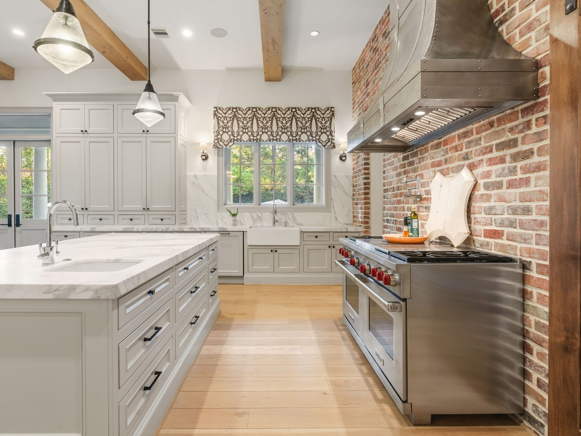 14 Peony Springs Court, The Woodlands, TX 77382 Quartzite counters, large farm style sink, dishwasher, vegetable sink and Wolf 6 burner / griddle and double oven complete the space.
